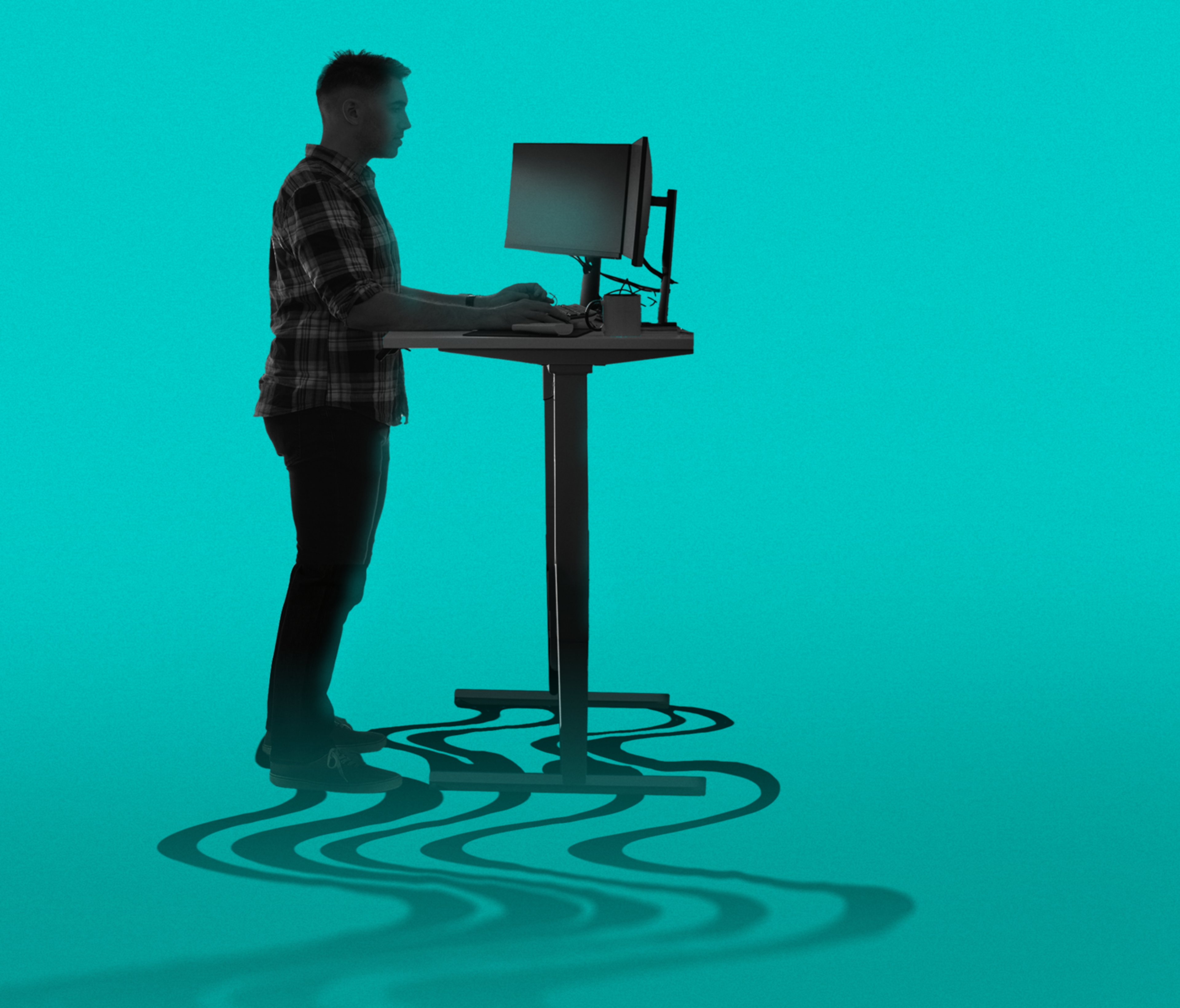 A person stands at a height-adjustable desk using a computer. Their shadow on the floor has a wavy pattern. The background is a solid teal color.