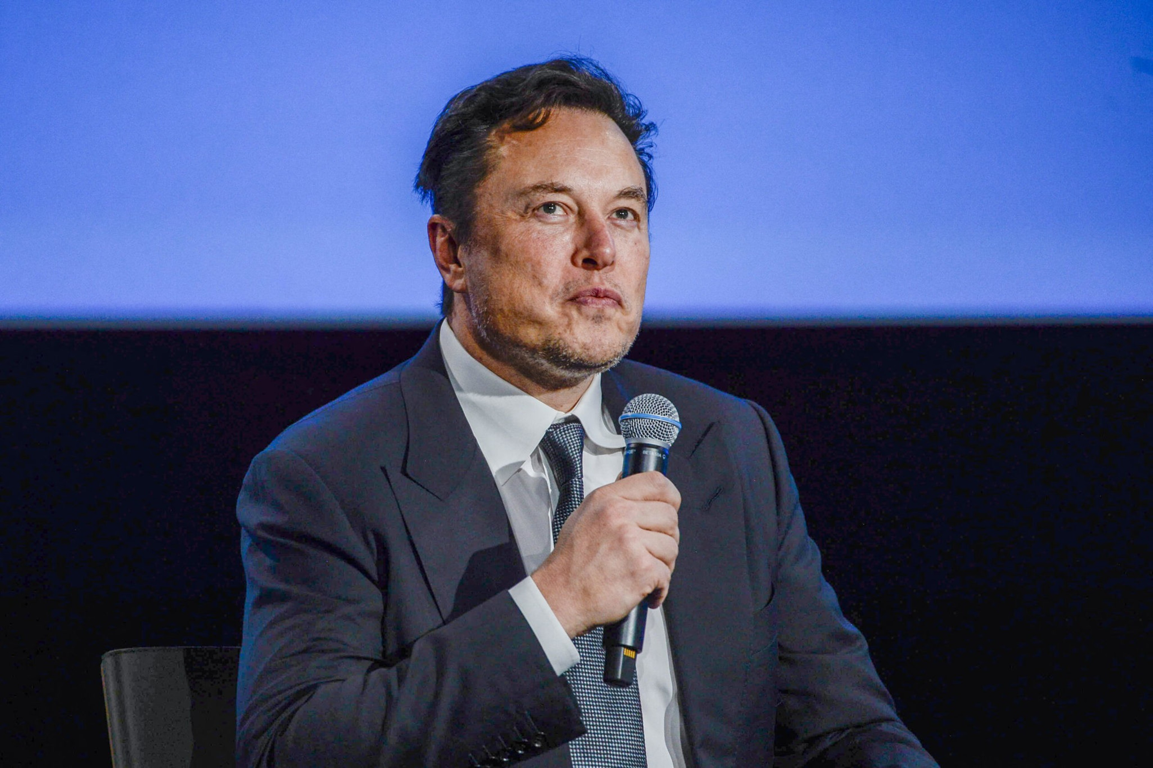 A man speaks into a microphone.