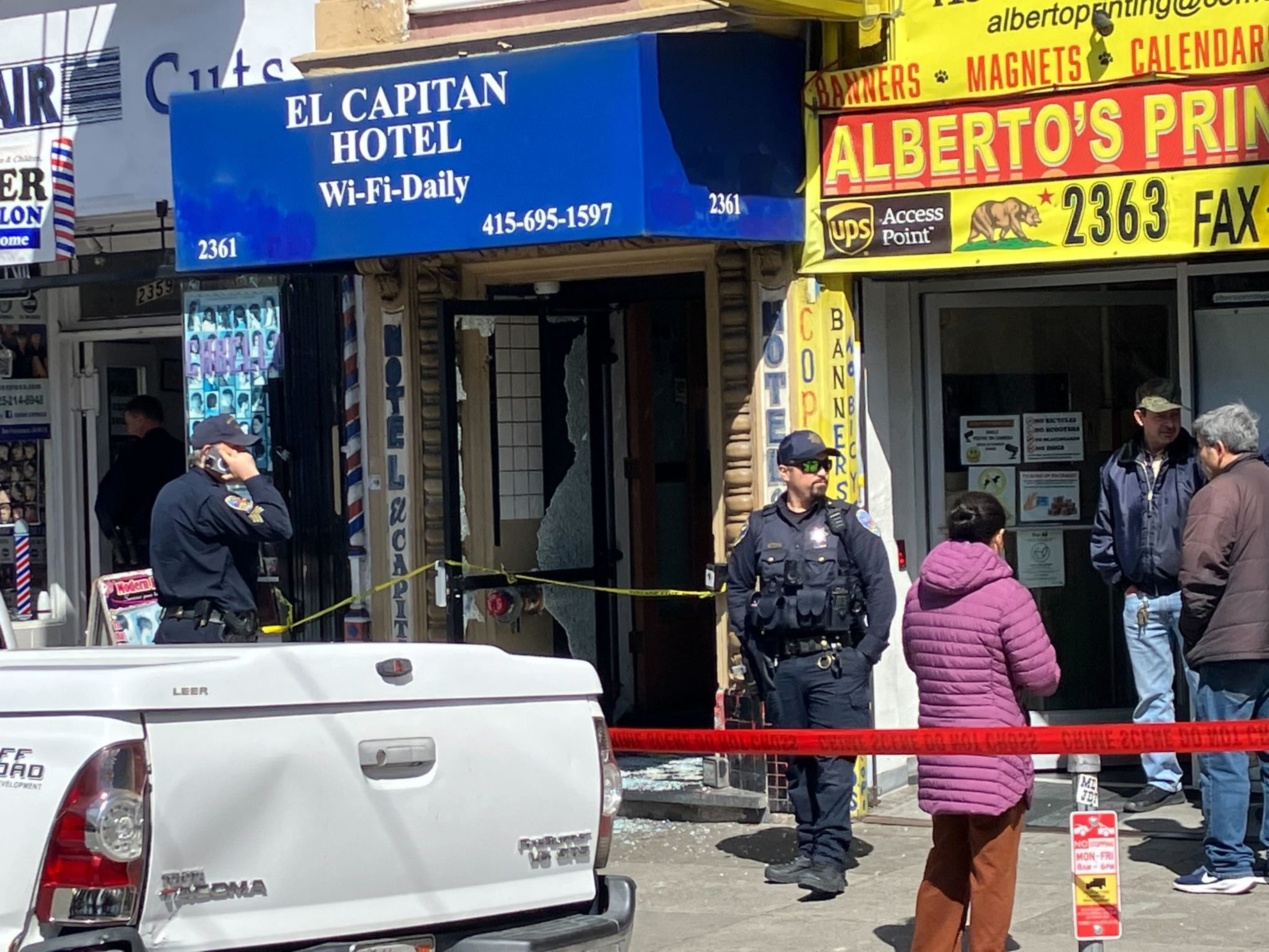 Police and bystanders outside a taped-off El Capitan Hotel; an incident seems to have occurred.