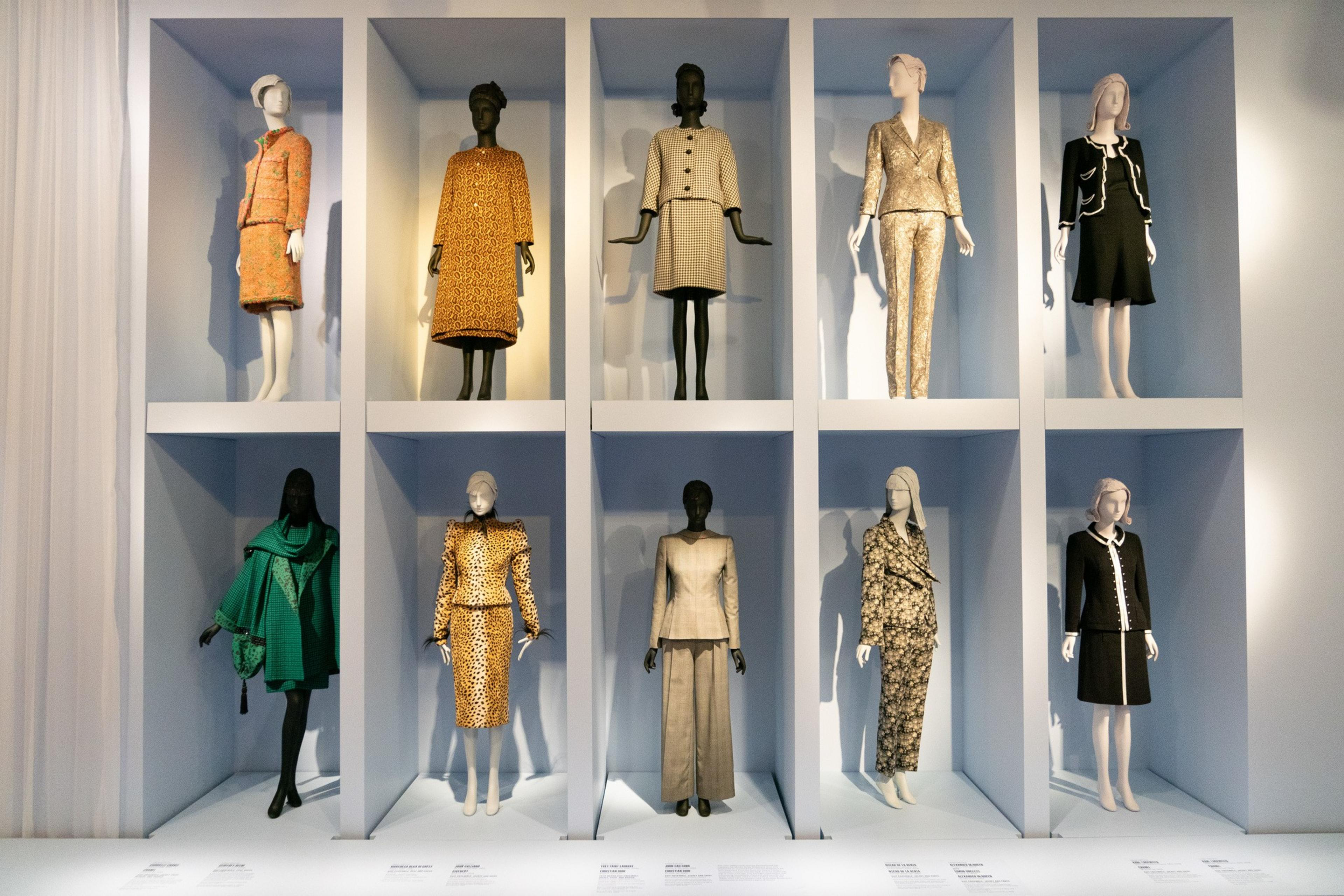 Two rows of mannequins wear fancy suits.