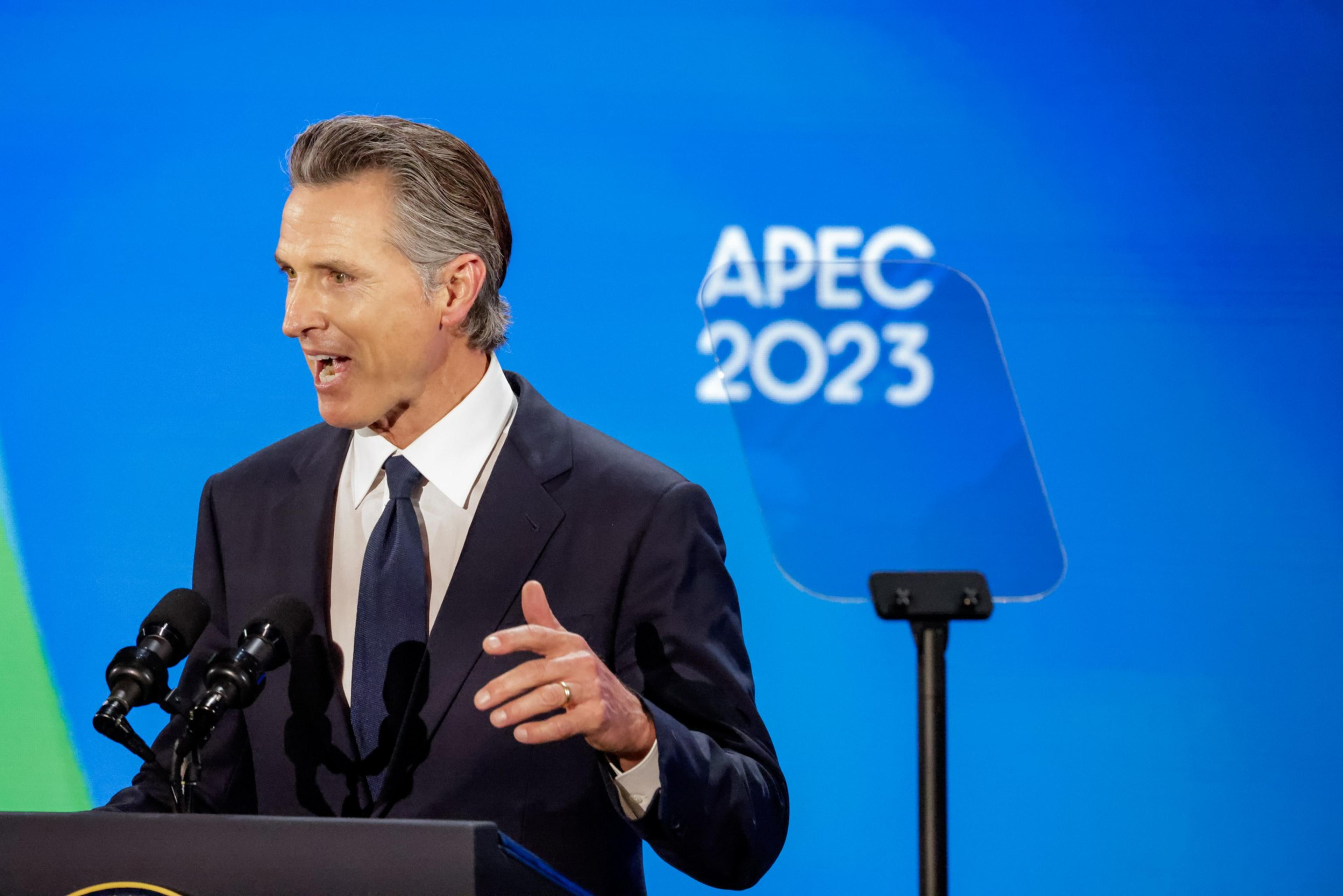 Gov. Gavin Newson gives a speech at a podium during President Joe Biden welcome party during APEC week. 