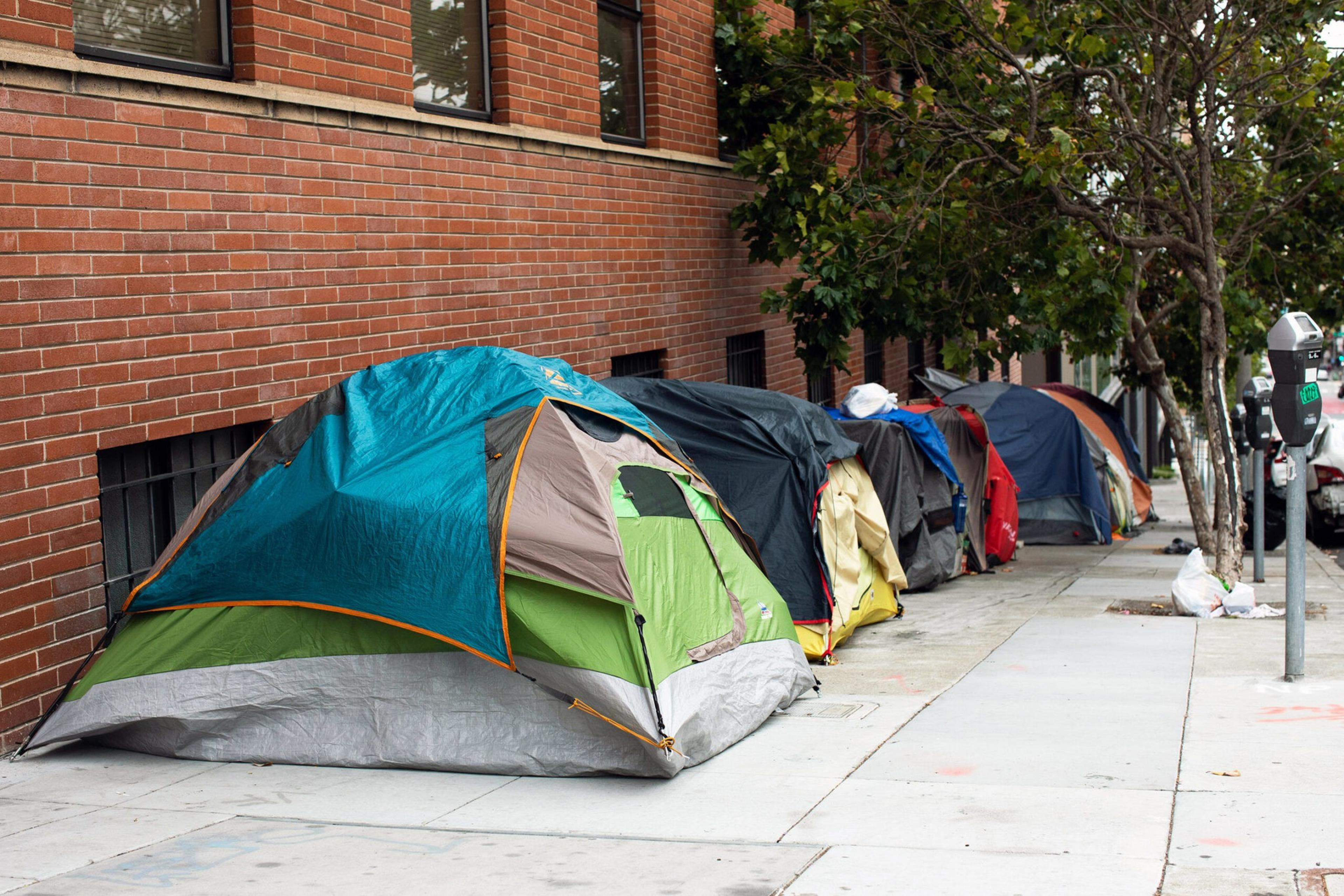 Row of tents on a strip of sidewalk