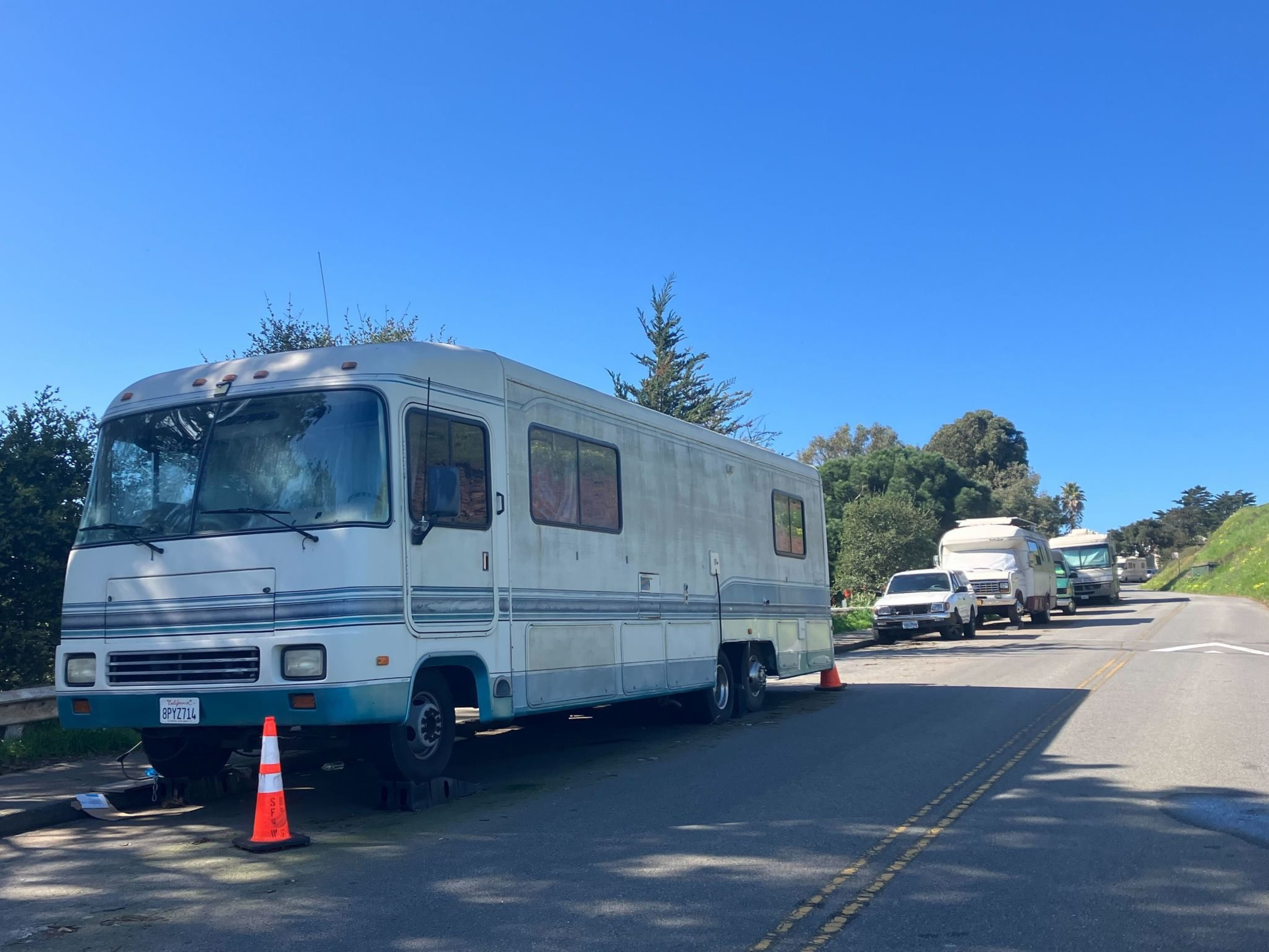 A line of RVs parked along a street