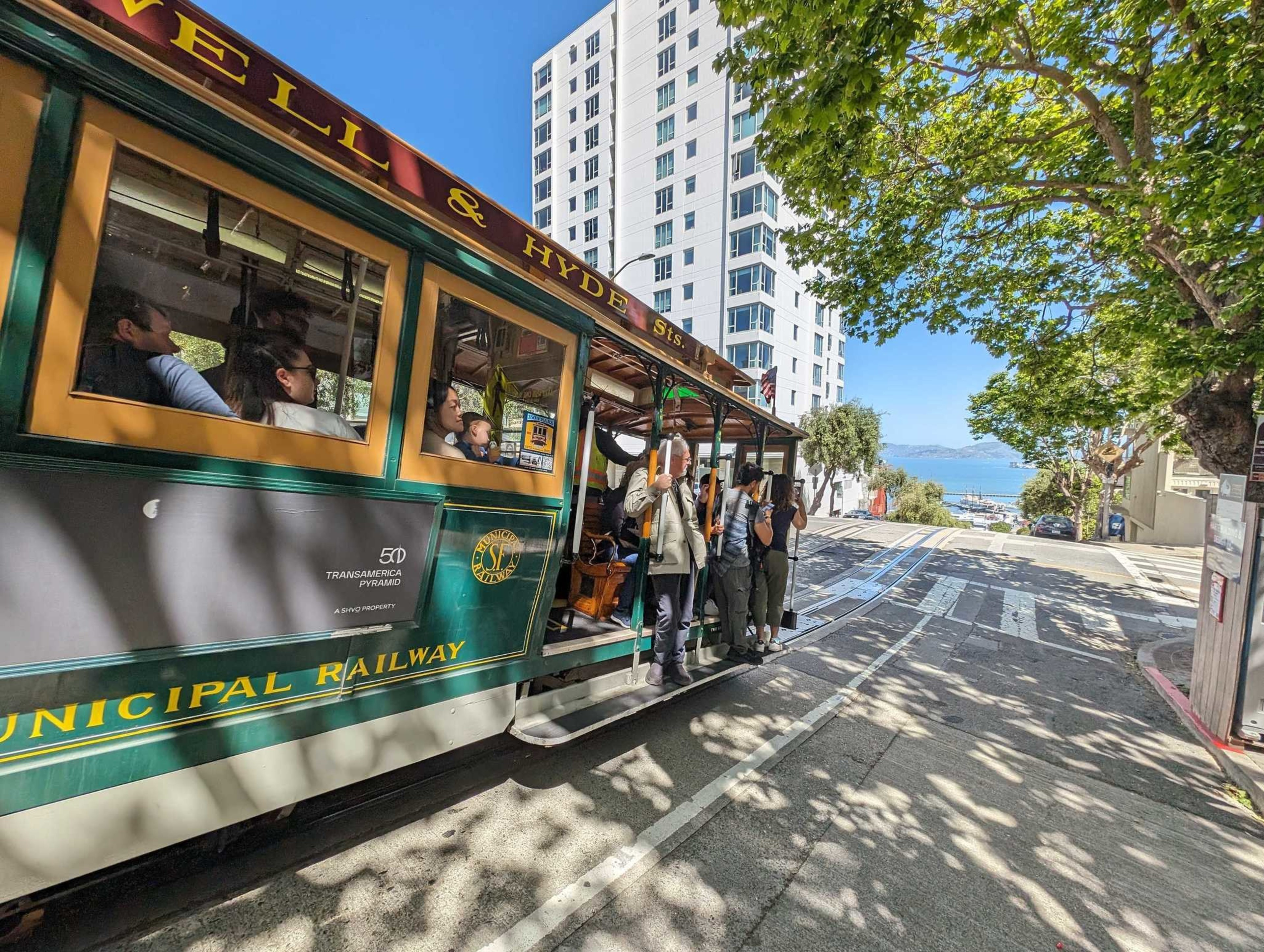 A cable car rides along a hilly street