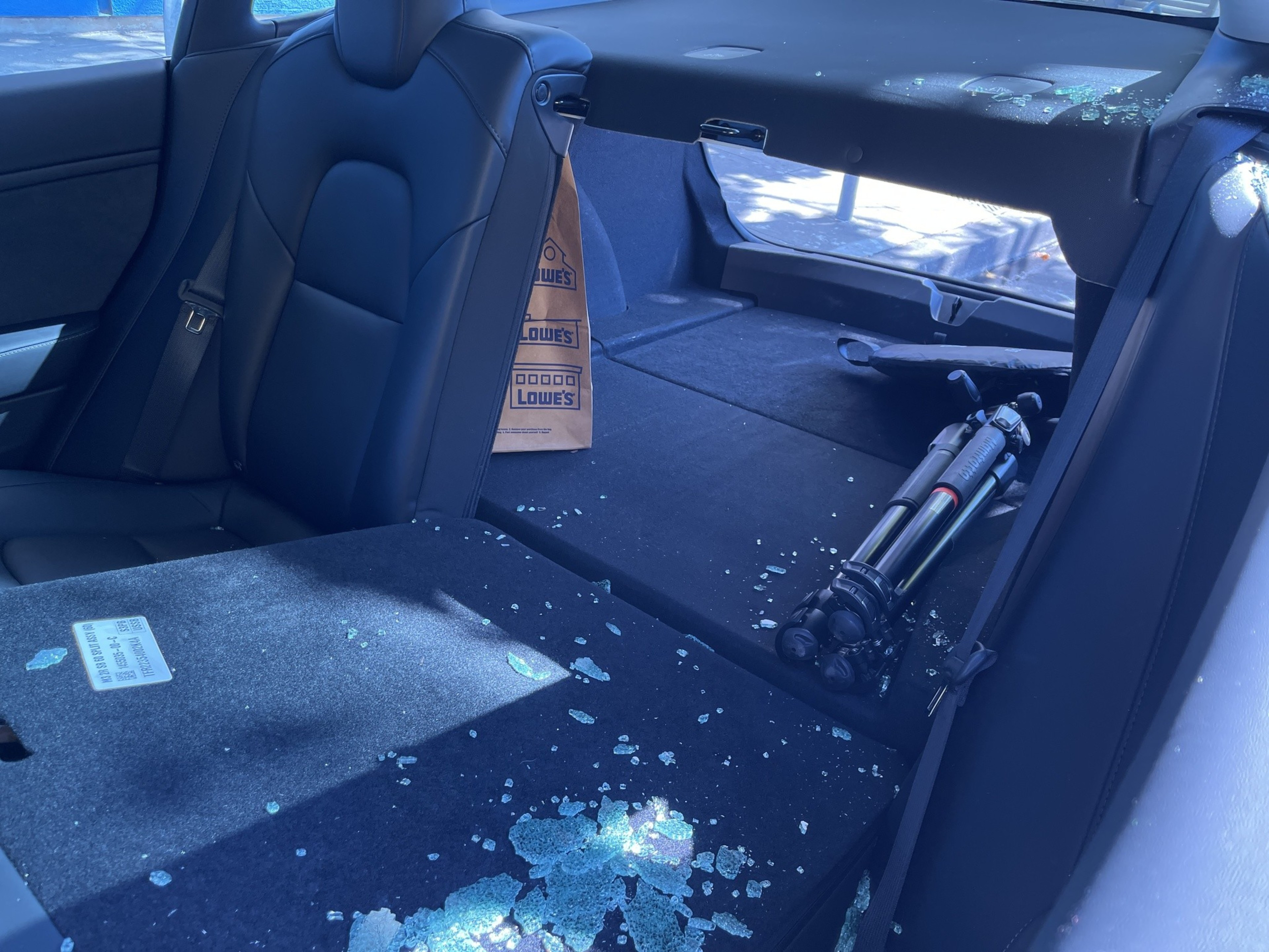 Broken glass litters the inside of a rented and broken-into 2023 Tesla Model S on Broadway near 24th Street in Oakland last Saturday.