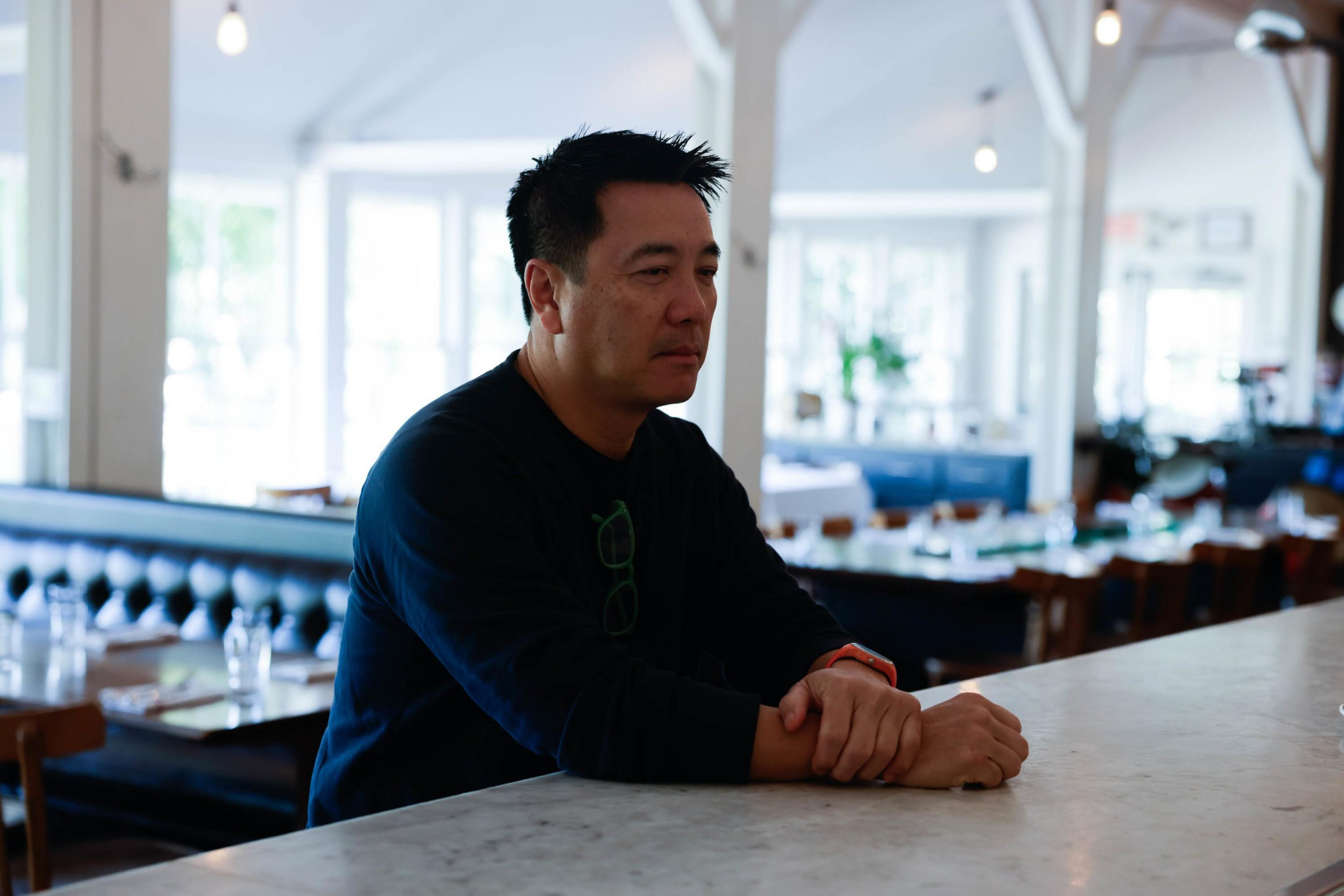 A man sits at a restaurant bar.