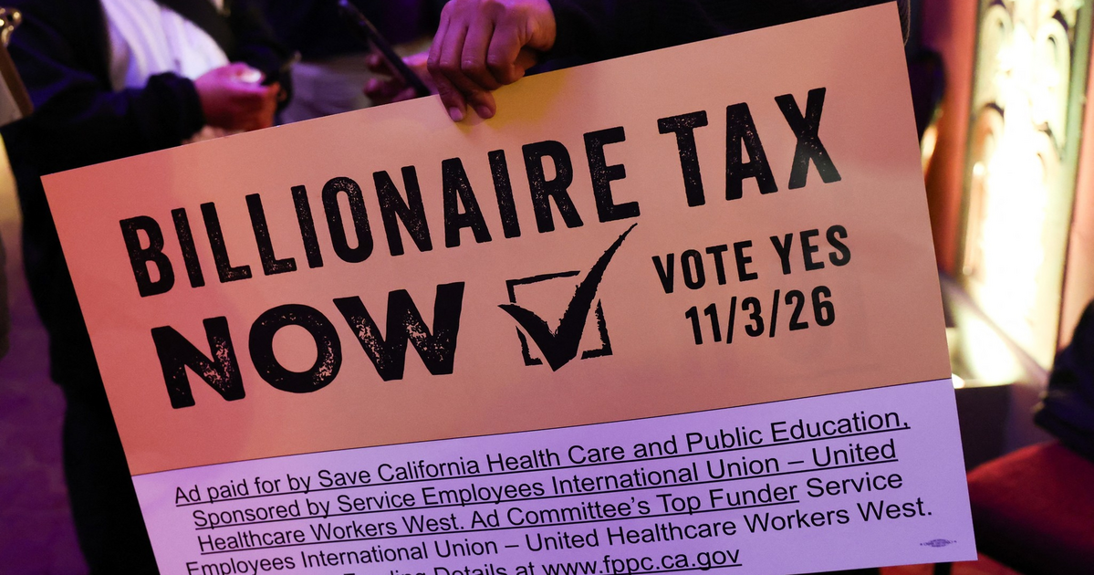A person holds a sign that reads "Billionaire Tax Now, Vote Yes 11/3/26," sponsored by health care and public education