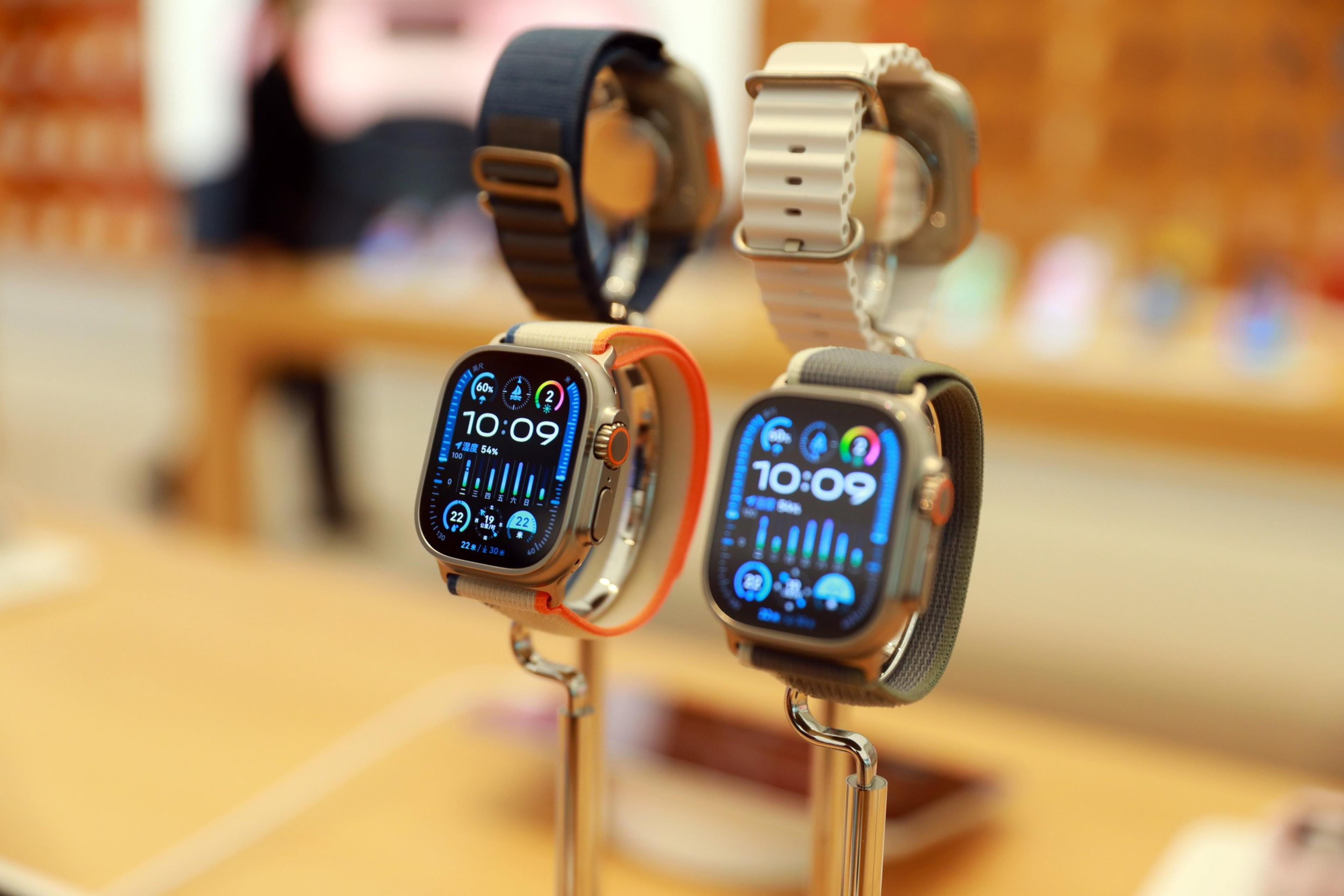 Four Apple watchesâ€”two with their faces visibleâ€”are on display