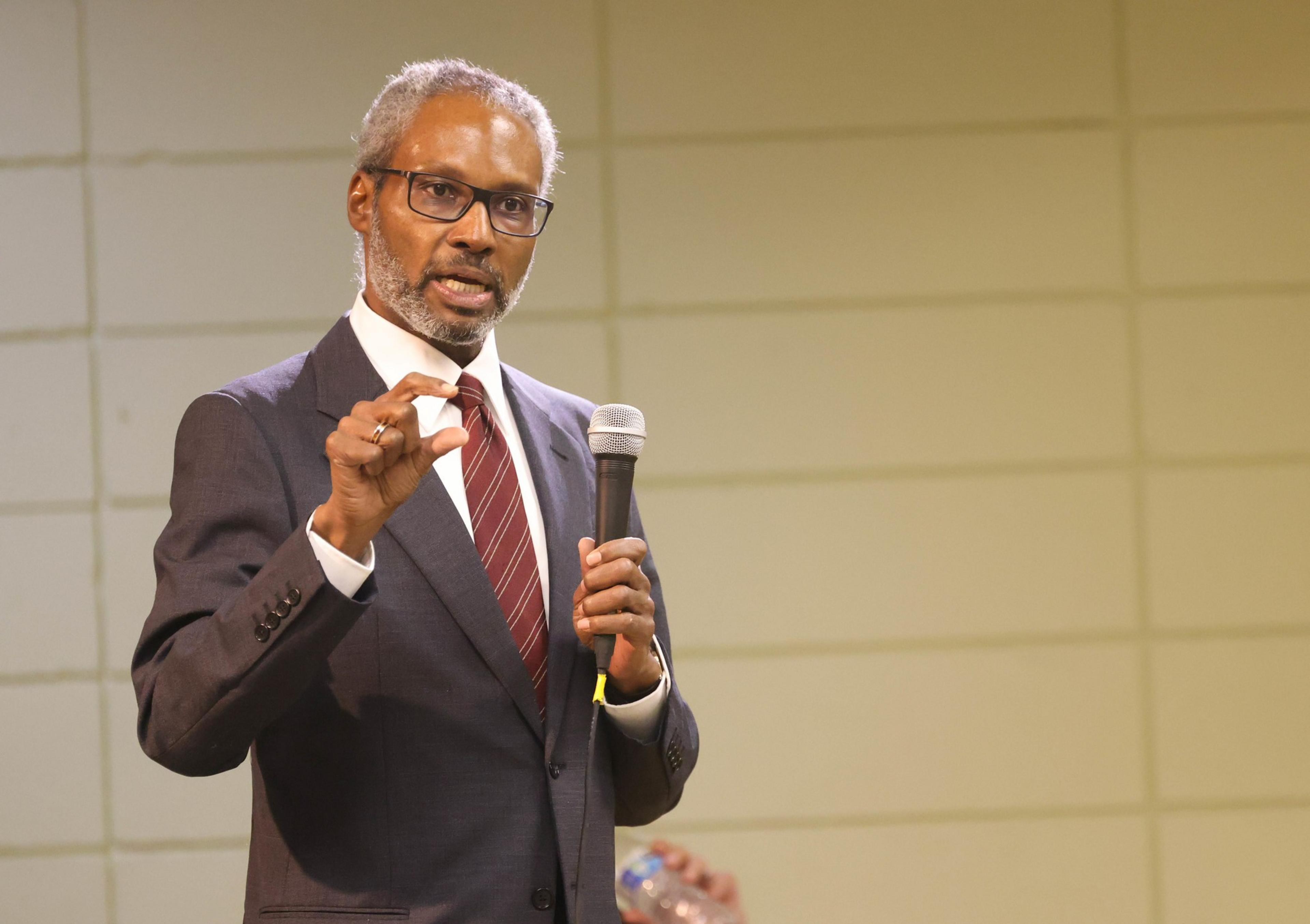 A man stands with a mic.