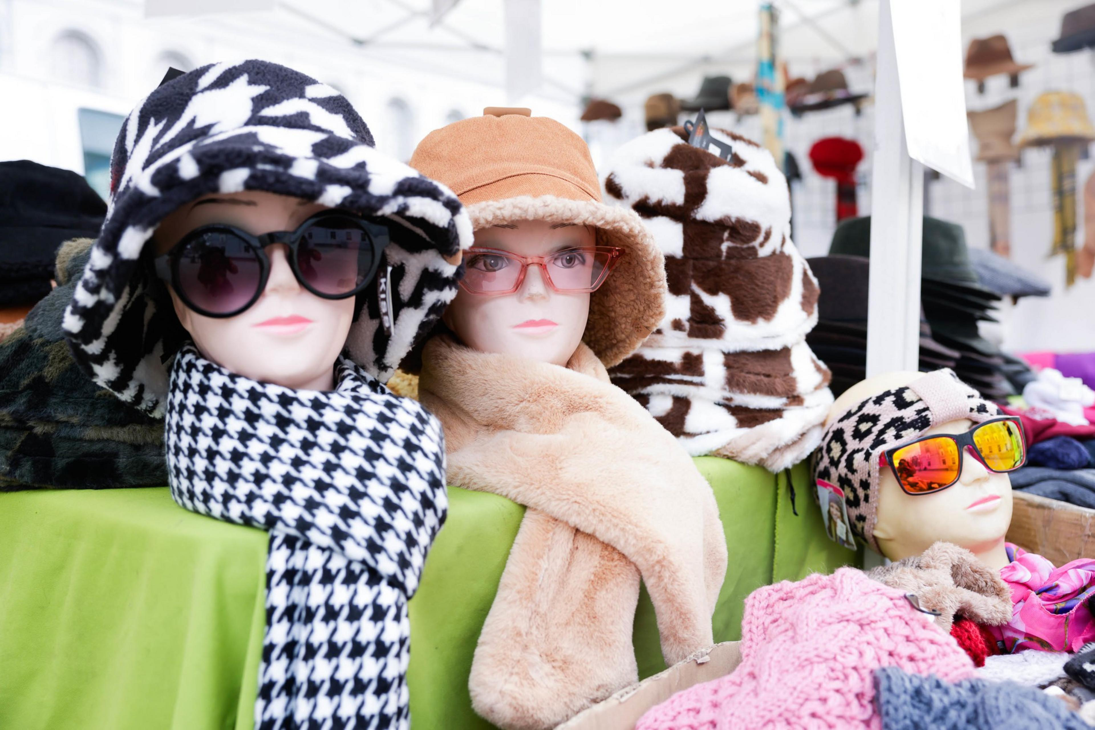 dummies sport womens hats, sunglasses and scarves on a merchandise table