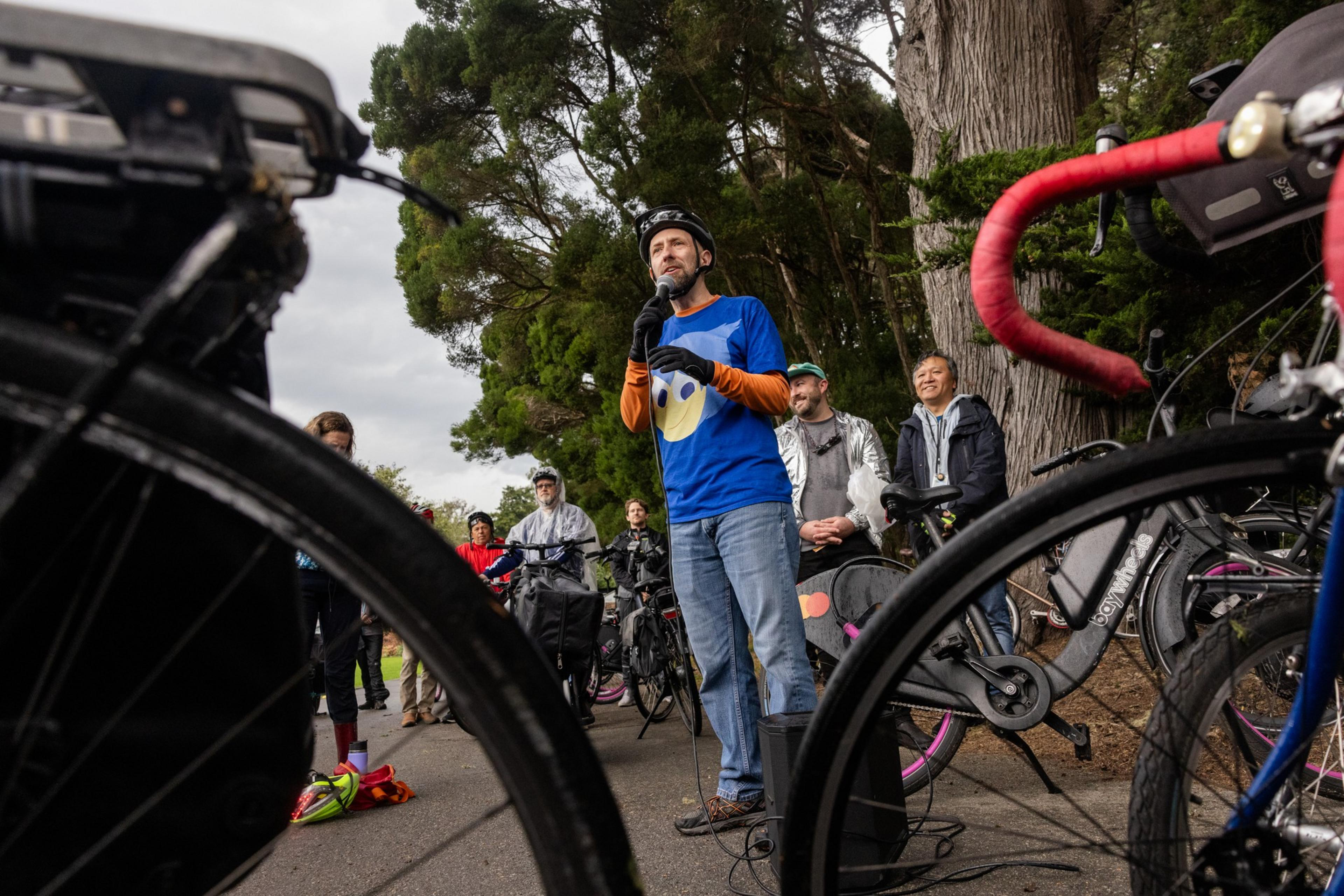 City Supervisor Joe Engardio speaks to people surround by bikes.