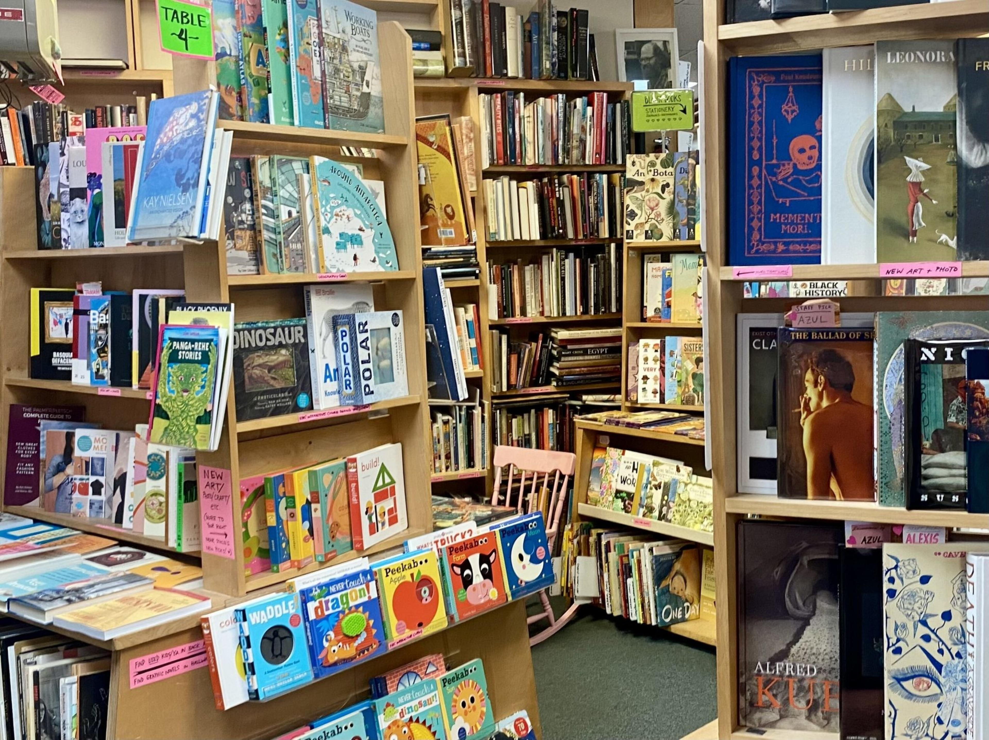 Shelves are crowded with books. 