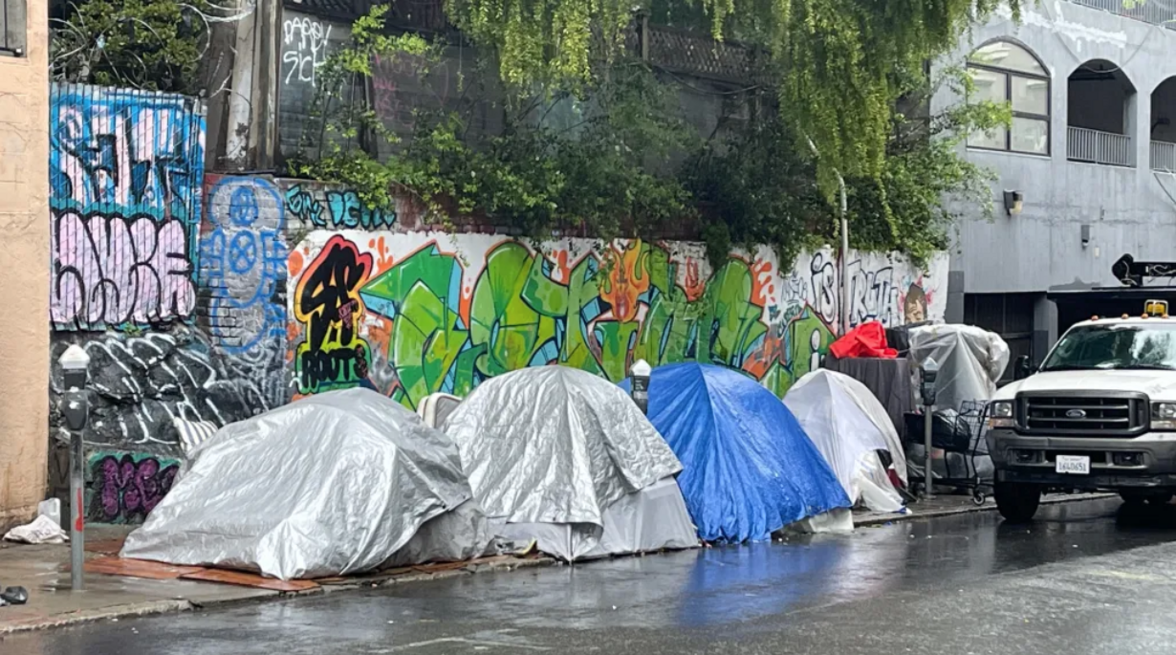 tents are seen along a sidewalk