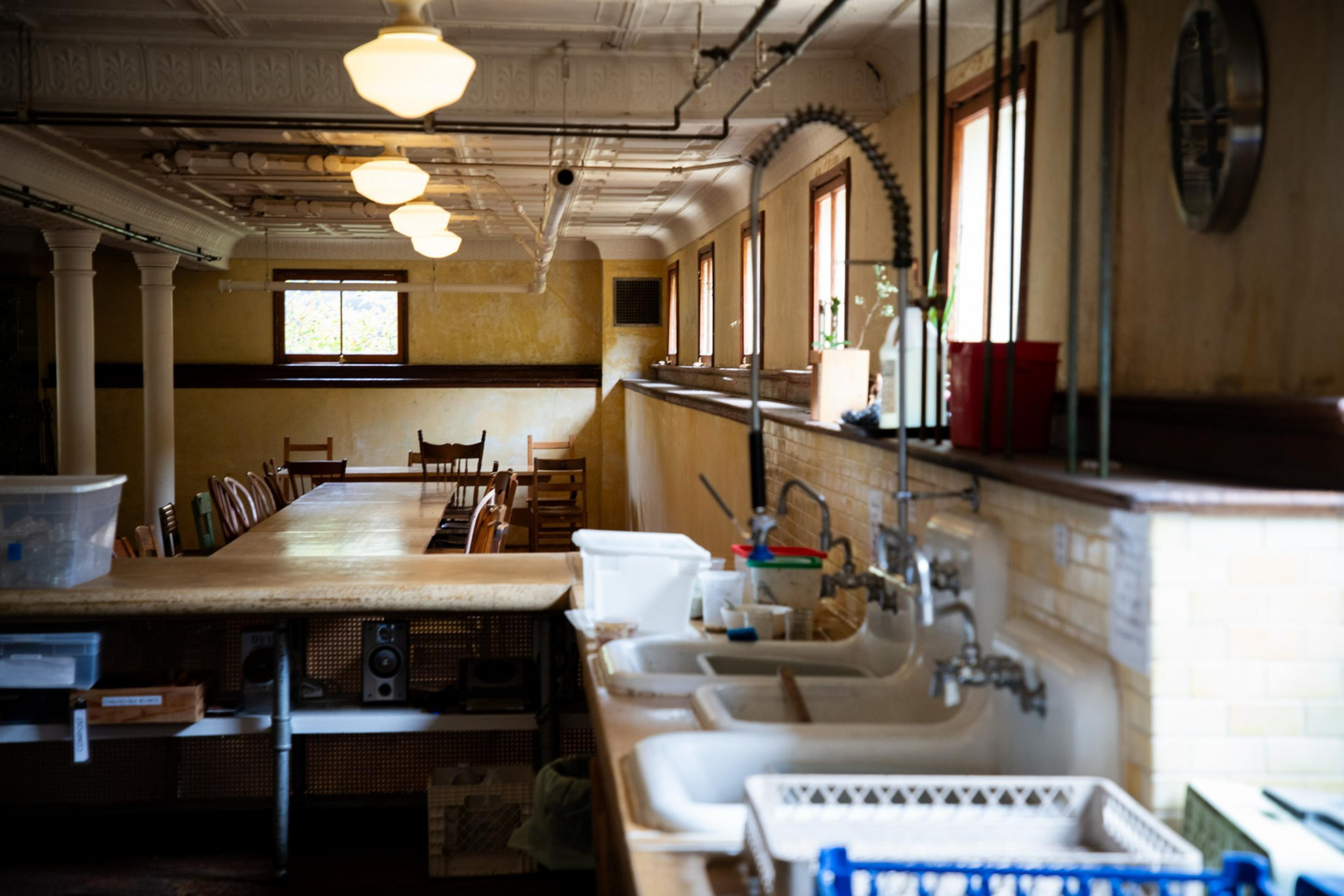 9335565168_MarinHeadlandsCenterArts_FZ_032 Sinks stand near the serving table and dining table inside the mess hall at the Headlands Center for the Arts on Wednesday, June 25. Staff prepare dinner for resident artists four nights a week.