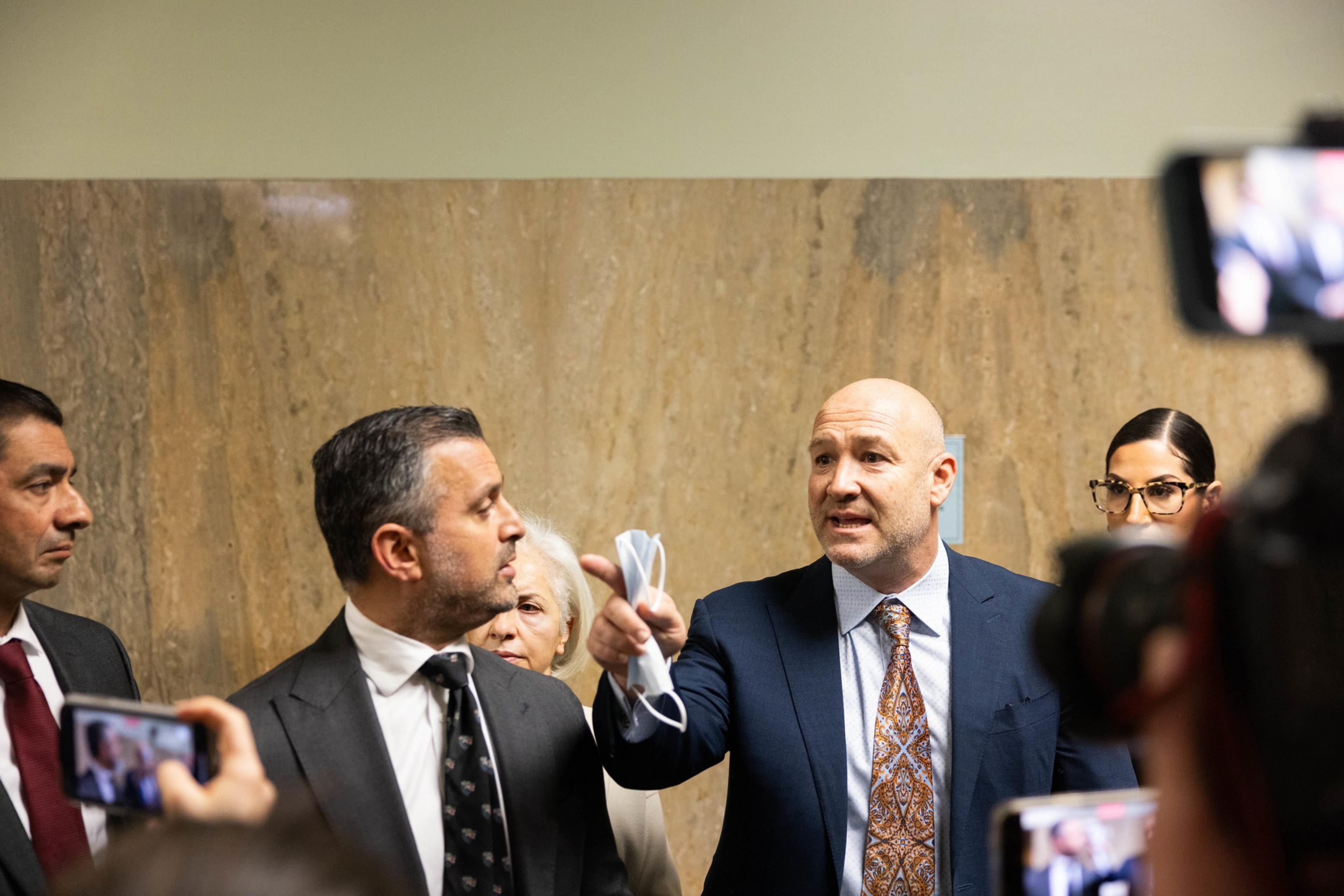 A press conference with lawyers speaking to the media.