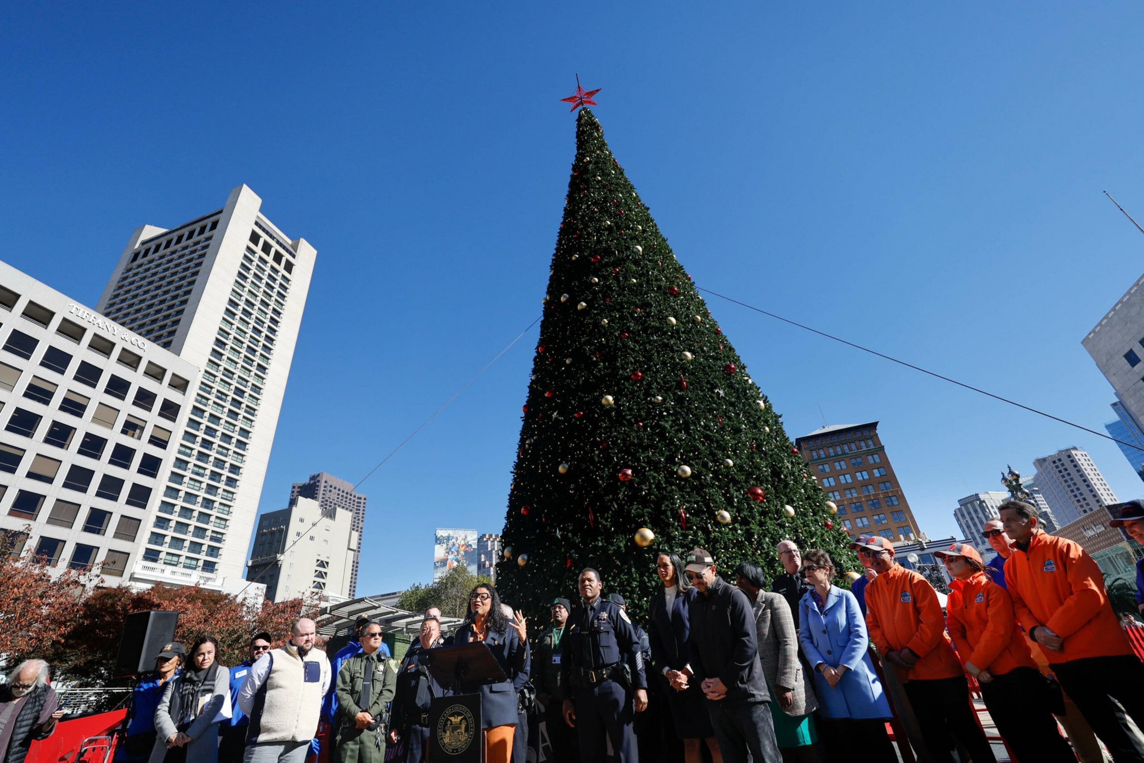 The Macyâ€™s building stands behind the Christmas tree at Union Square in San Francisco on Friday, Dec. 9, 2022. | Benjamin Fanjoy/The Standard