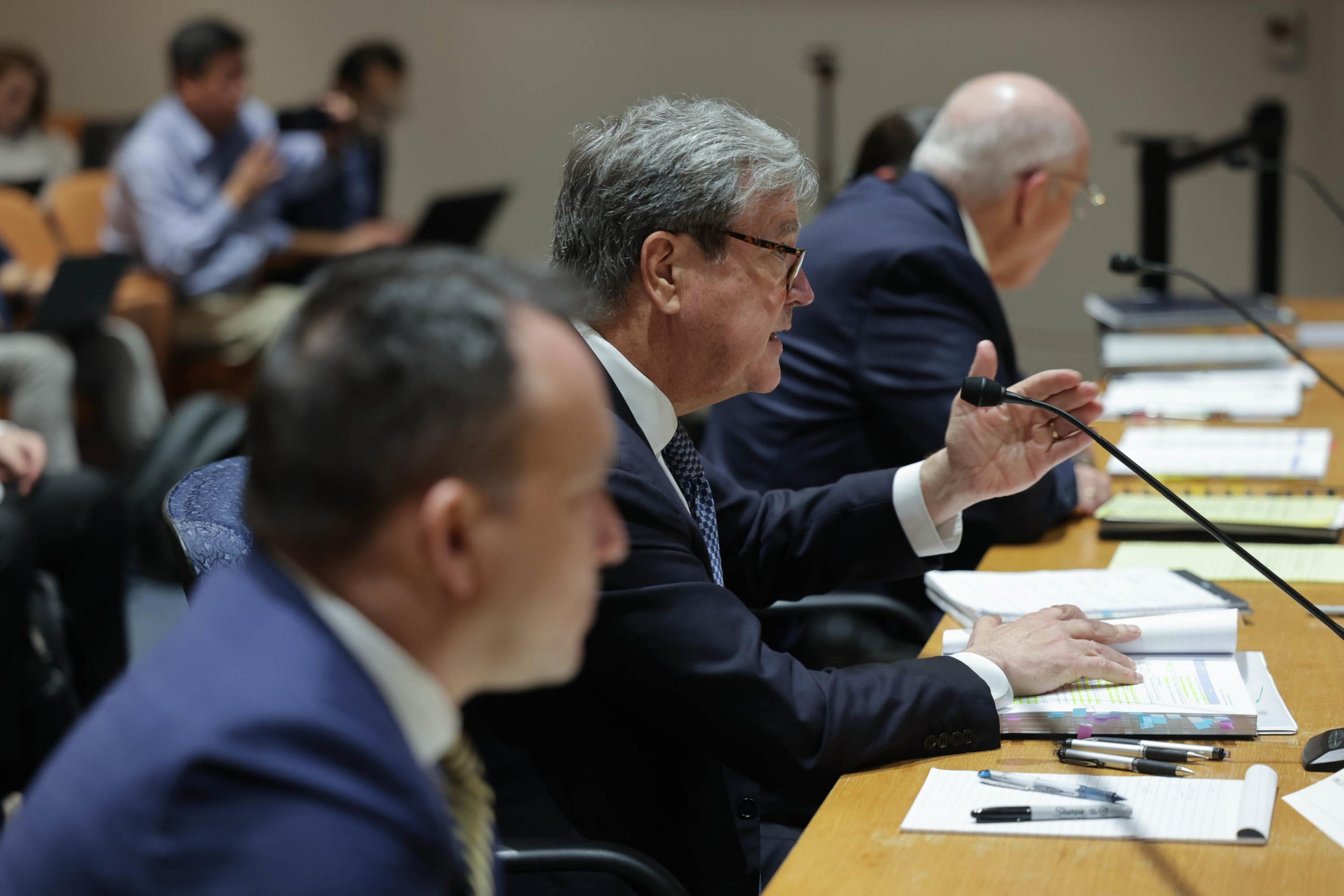 man speaks at hearing