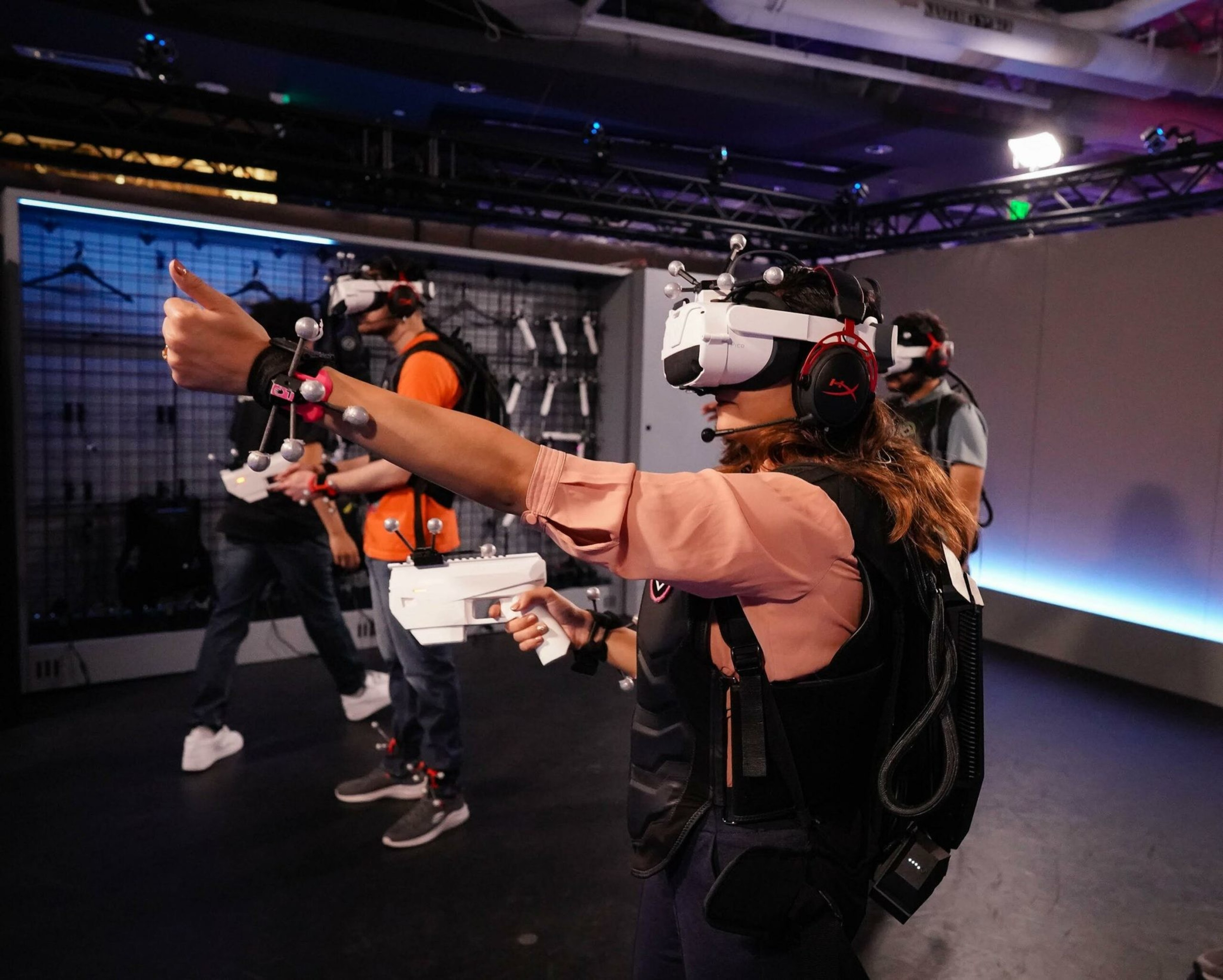 Some people wearing virtual reality glasses also holding VR controllers