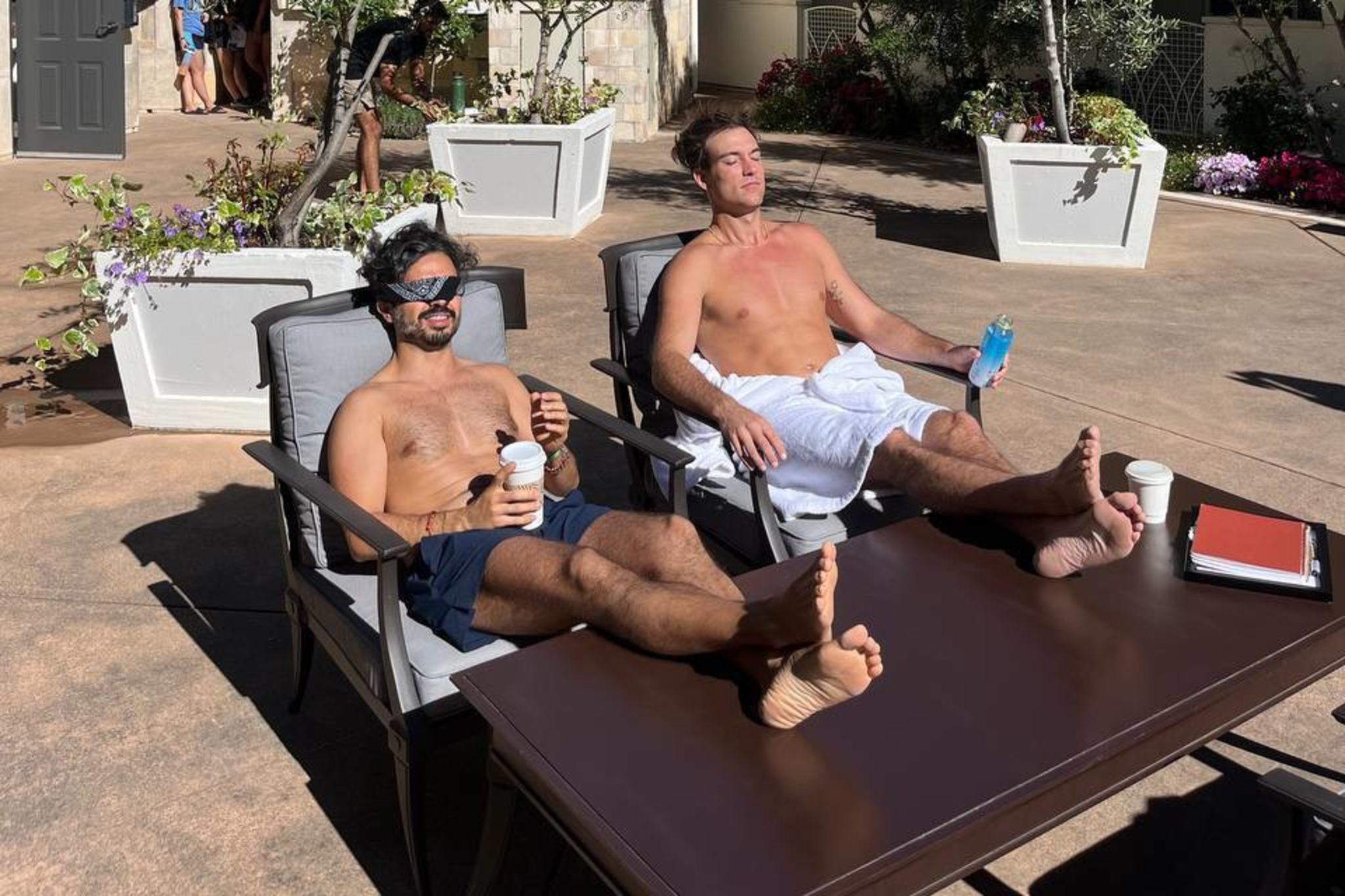 Attendees sunbathe after enjoying a cold plunge during Edge Esmeralda