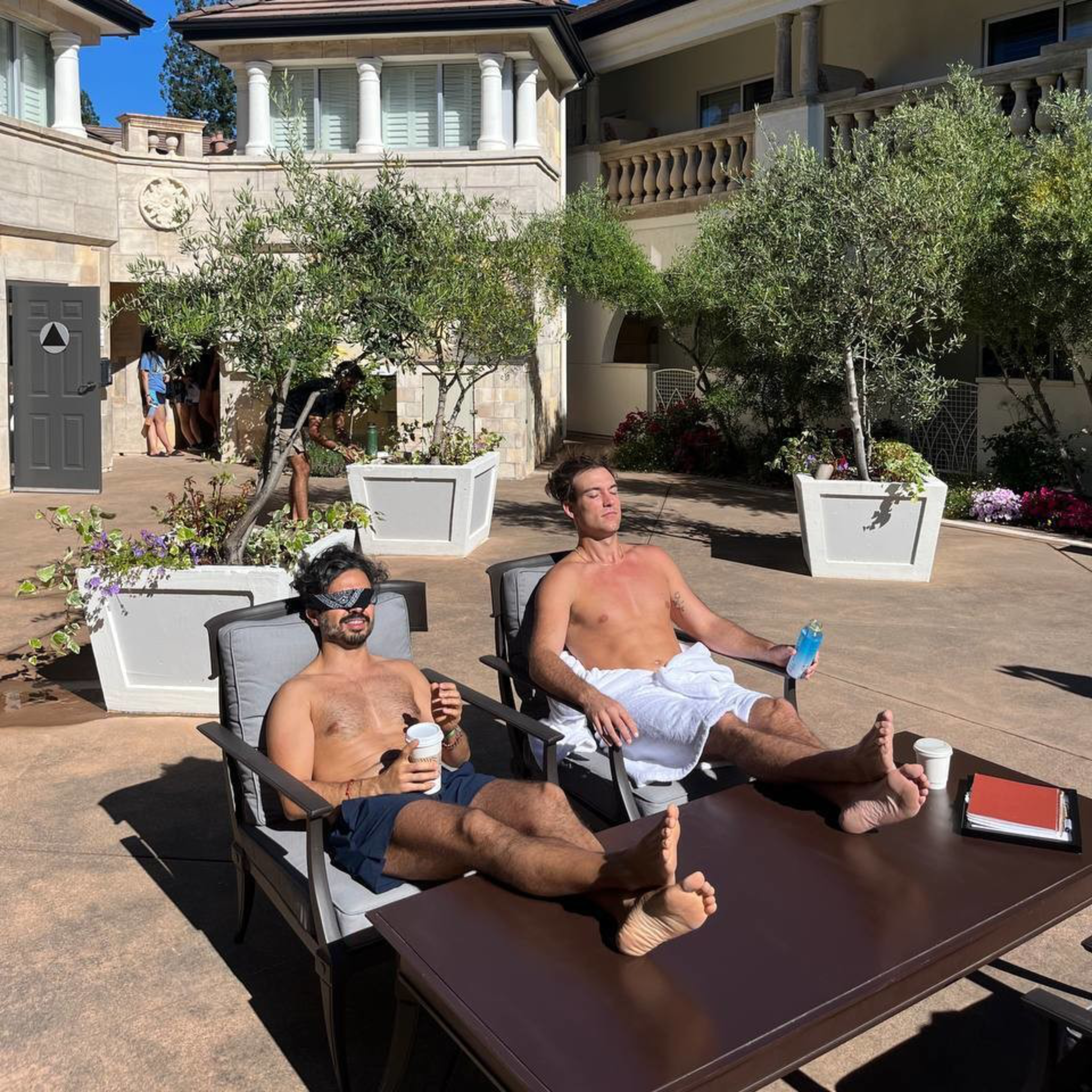 Attendees sunbathe after enjoying a cold plunge during Edge Esmeralda