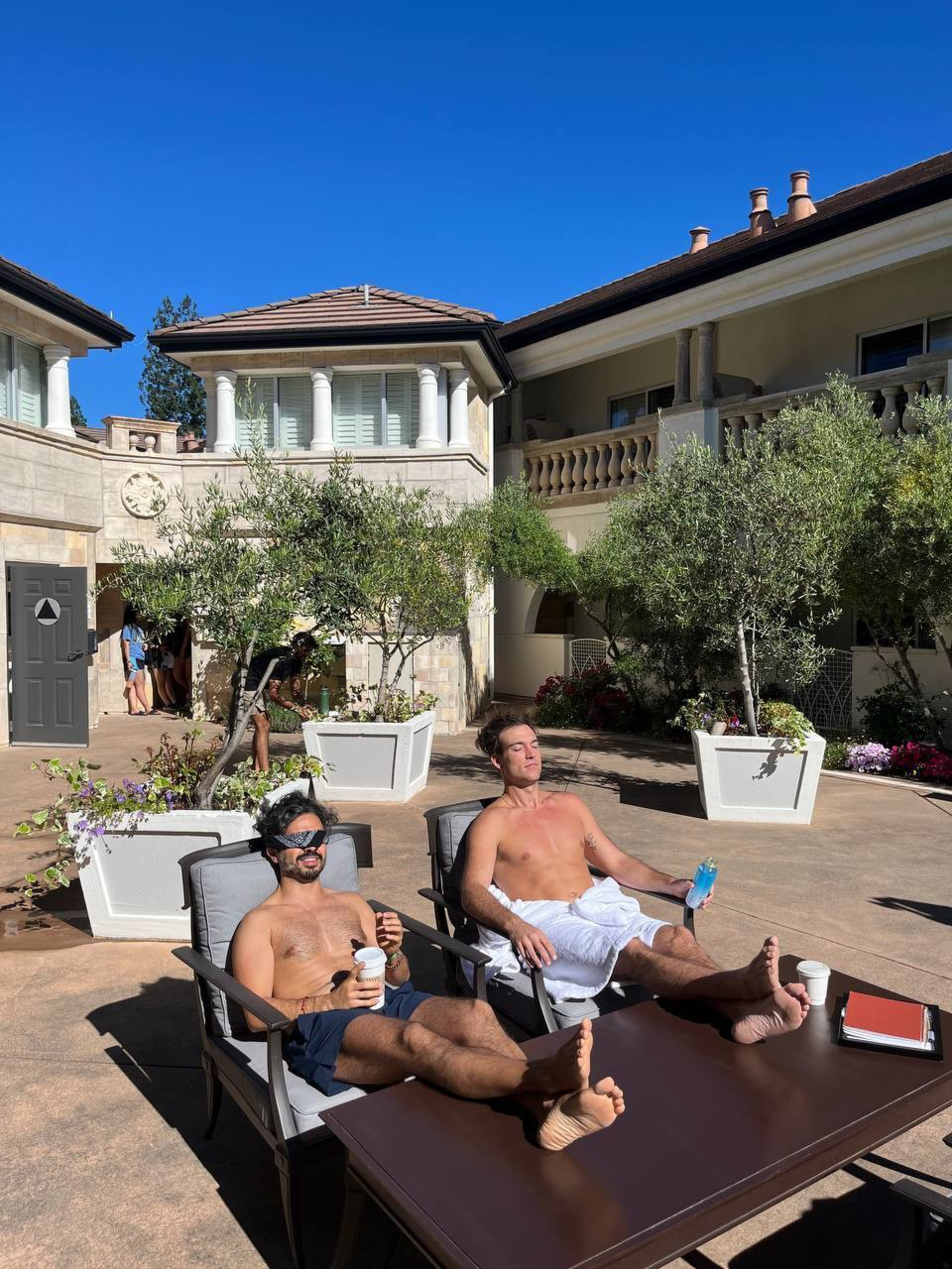 Attendees sunbathe after enjoying a cold plunge during Edge Esmeralda
