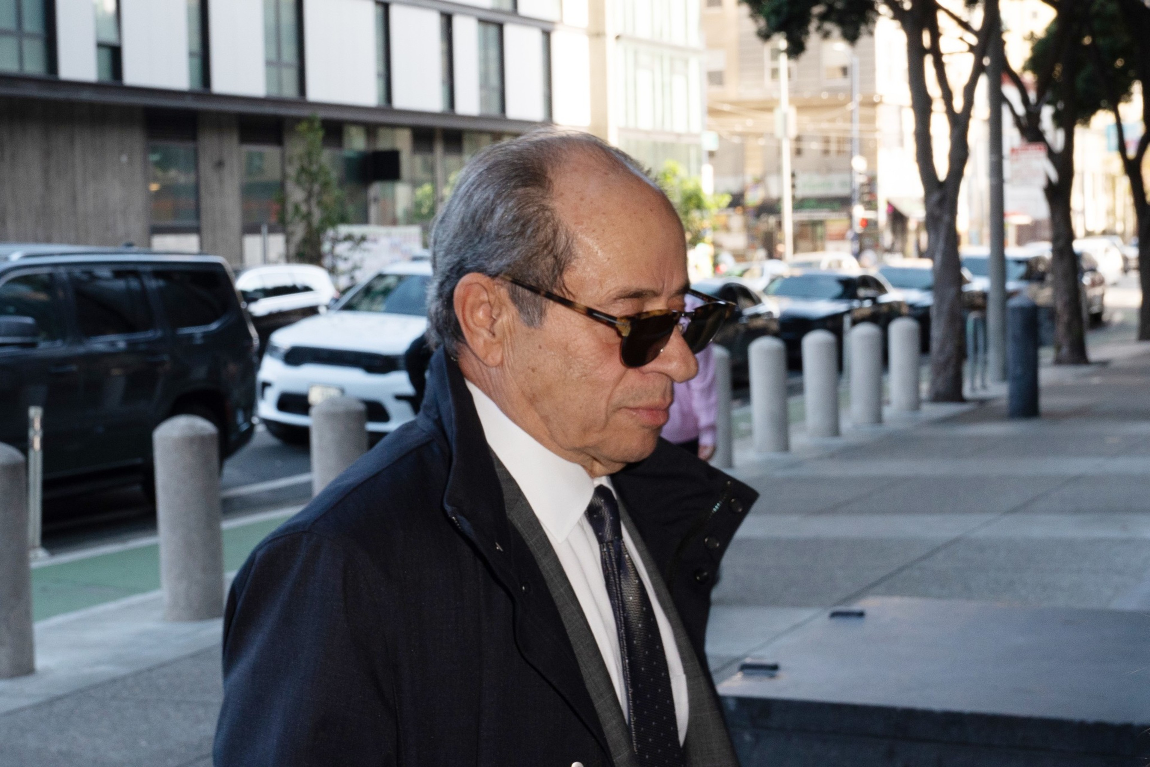 A man in a suit walks into court