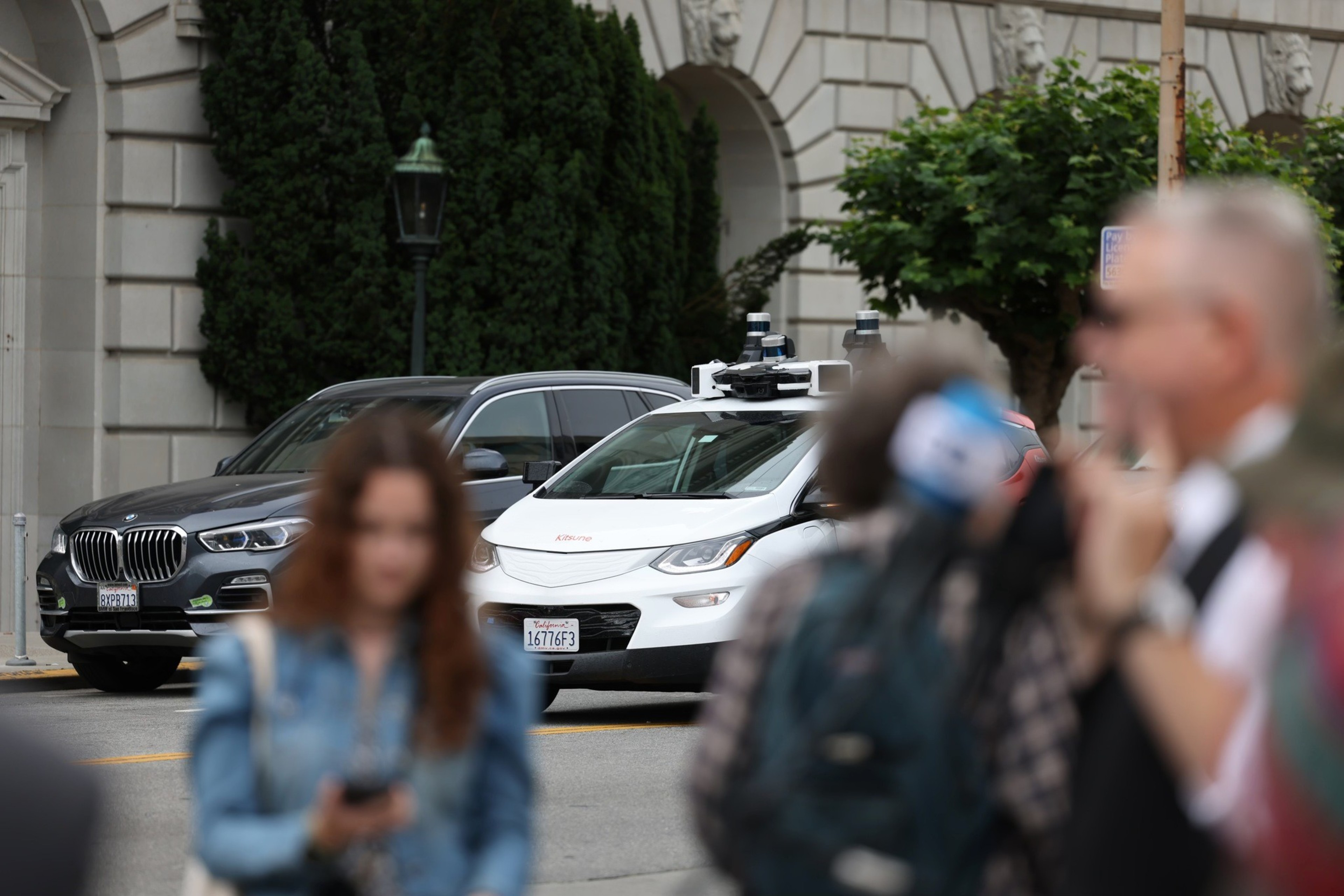 A robotaxi and pedestrians.