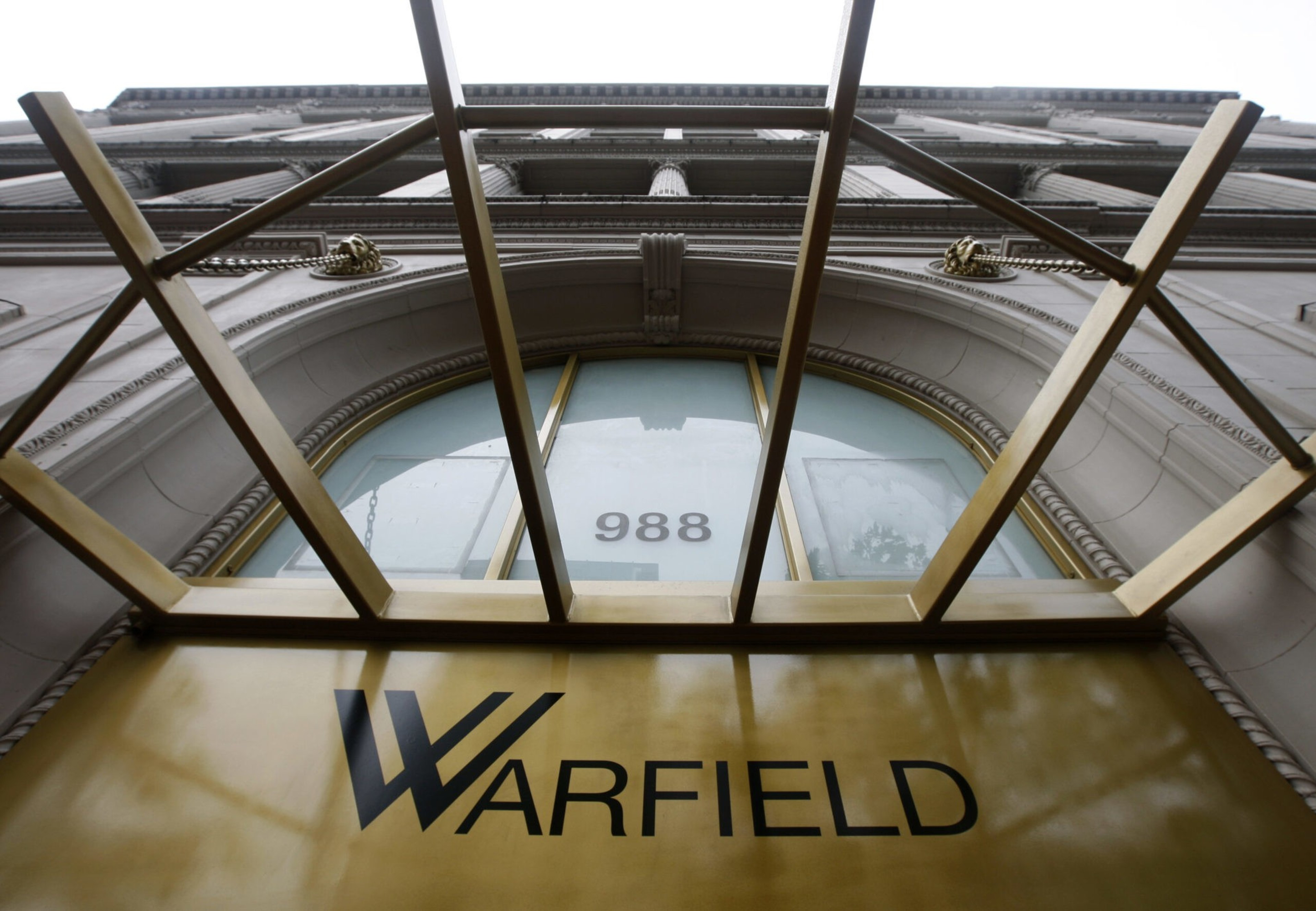 The image shows a building entrance with a golden awning frame. The word &quot;Warfield&quot; is displayed prominently, and the number &quot;988&quot; is visible above.