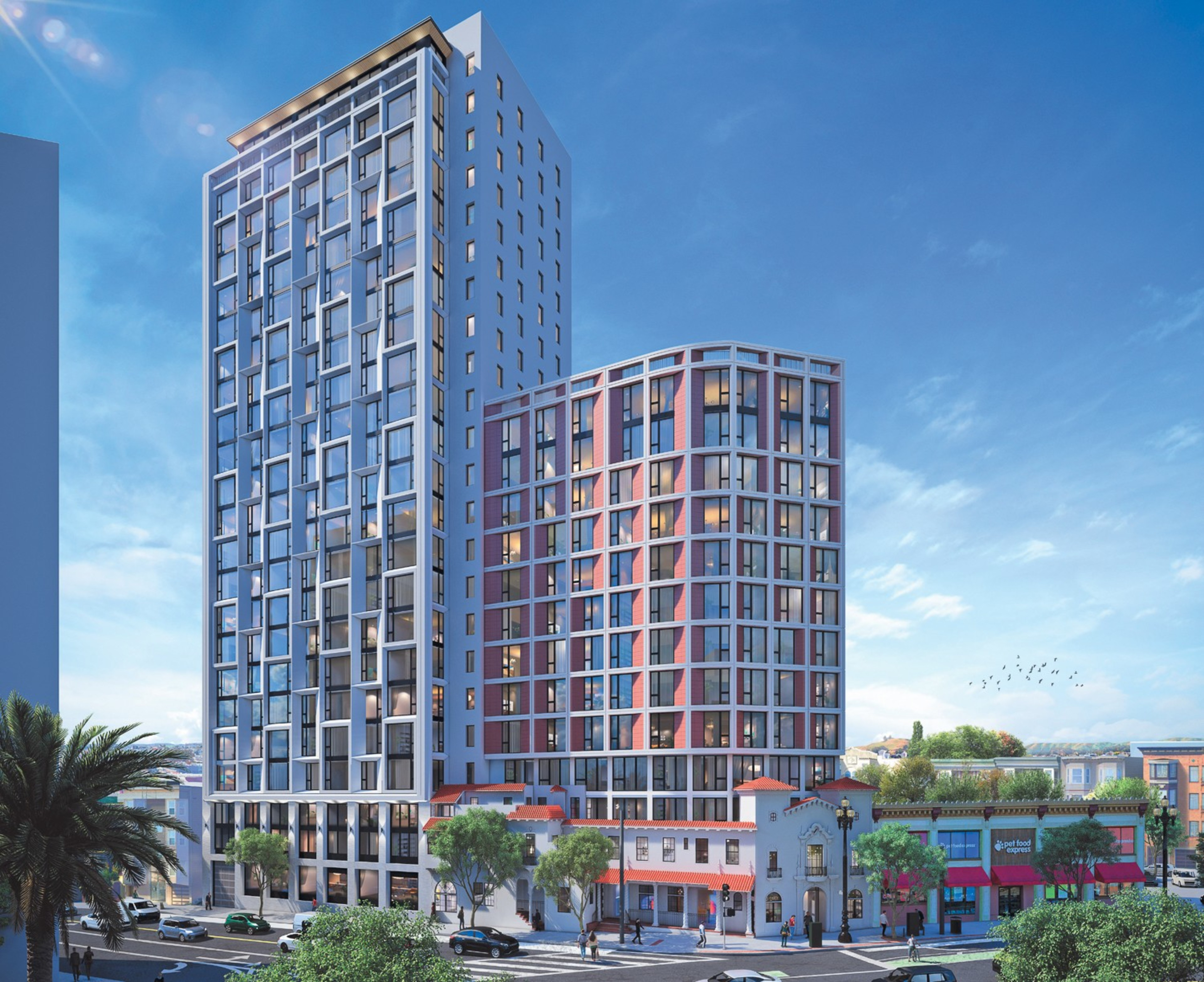 The image shows two modern, high-rise buildings with many windows, adjacent to a traditional, colorful low-rise structure on a busy street lined with trees and parked cars.