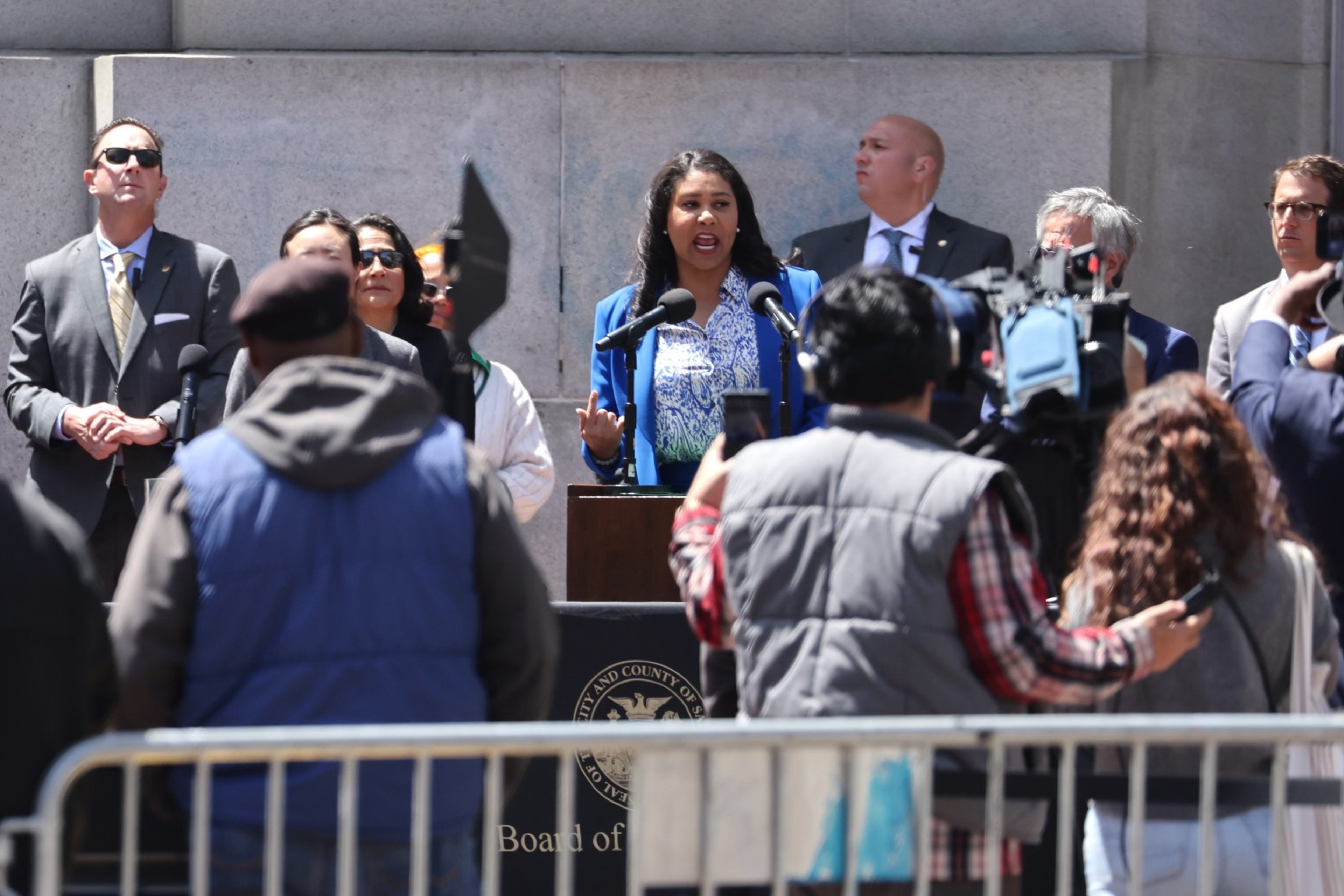 Mayor London Breed stands before a crowd at UN Plaza