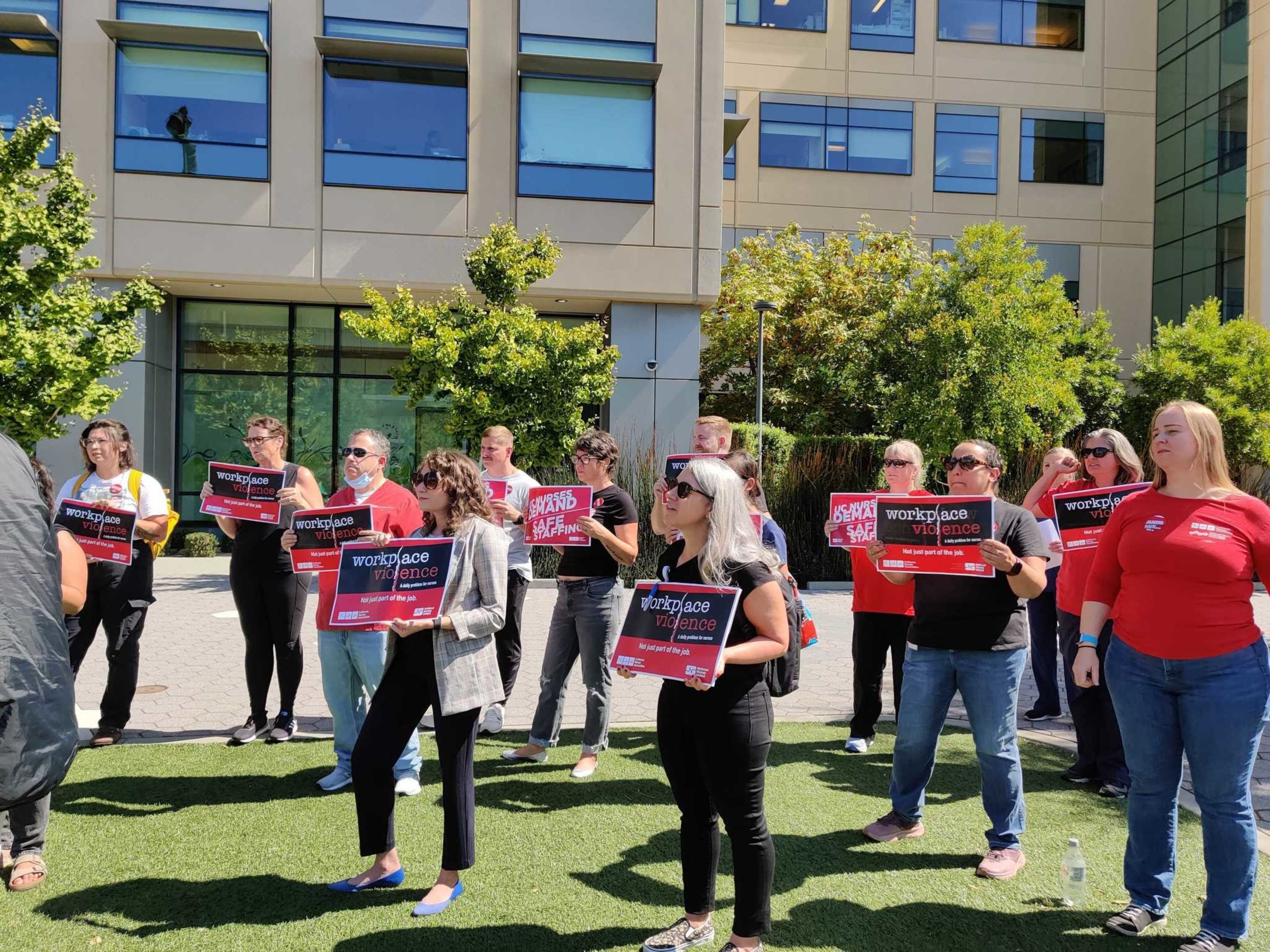 Nurses protest outside of a hospital.