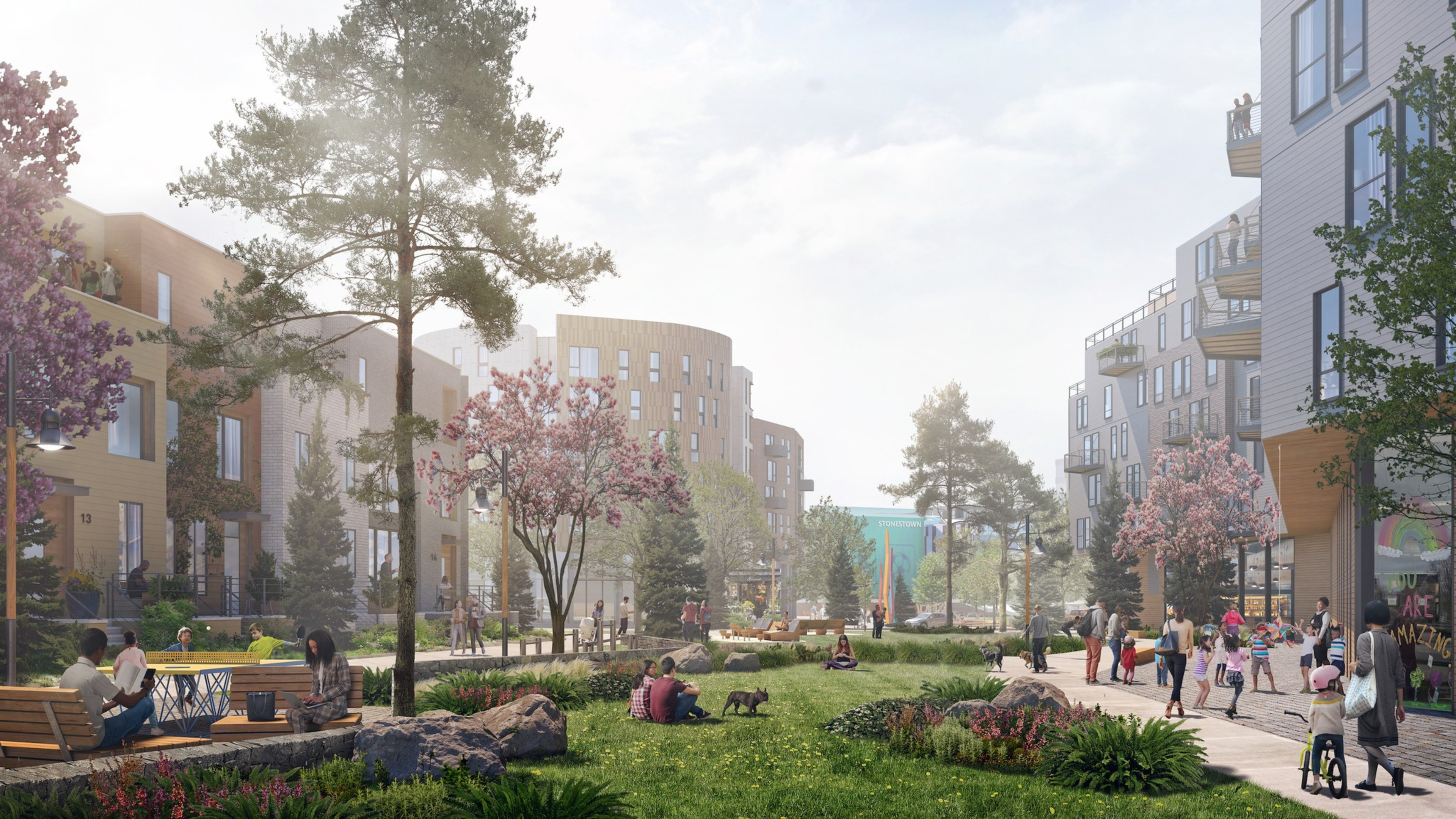 A grassy lawn with trees and sidewalks is surrounded by buildings boasting housing.