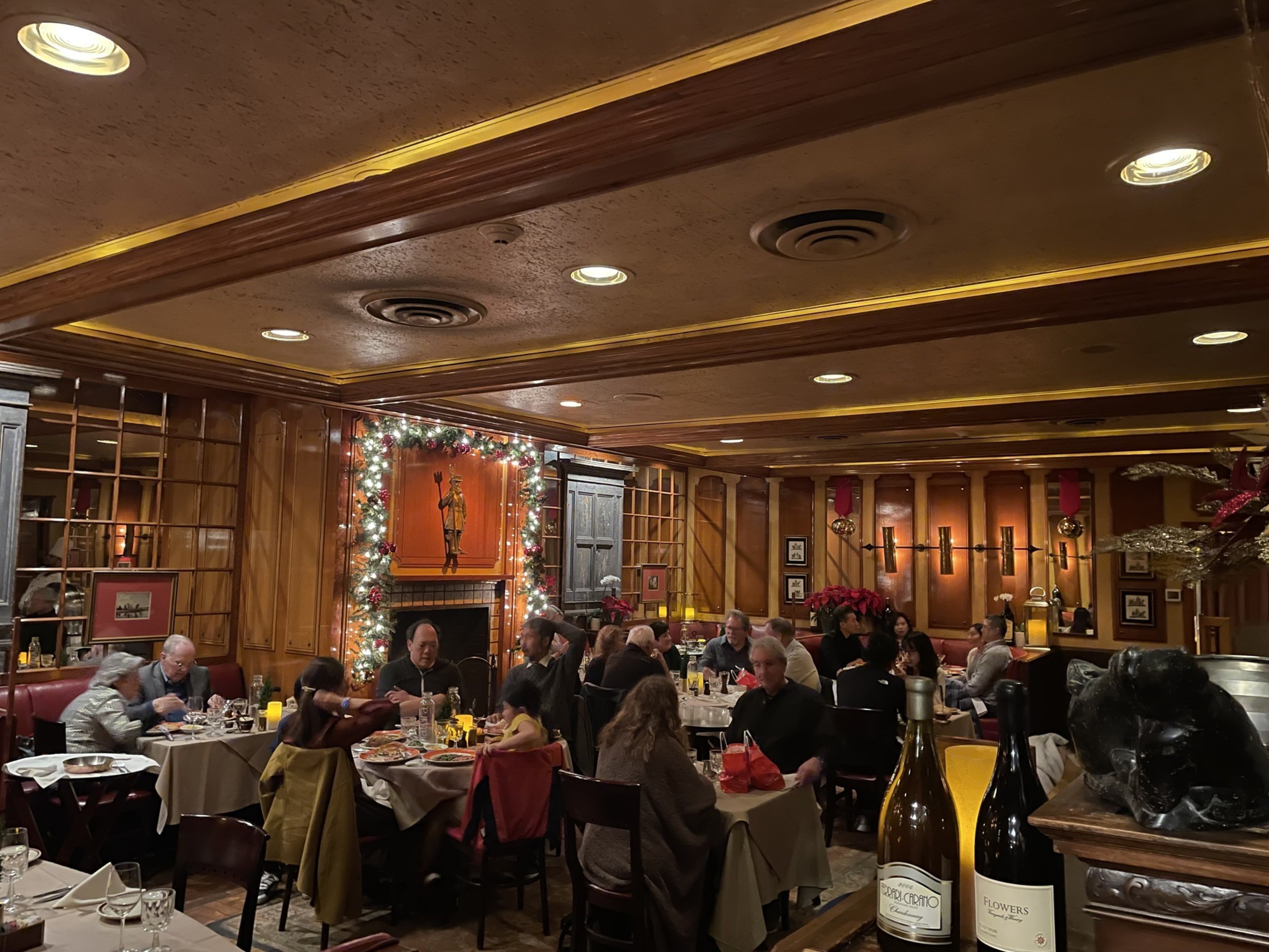 A restaurant interior is filled with diners at tables.