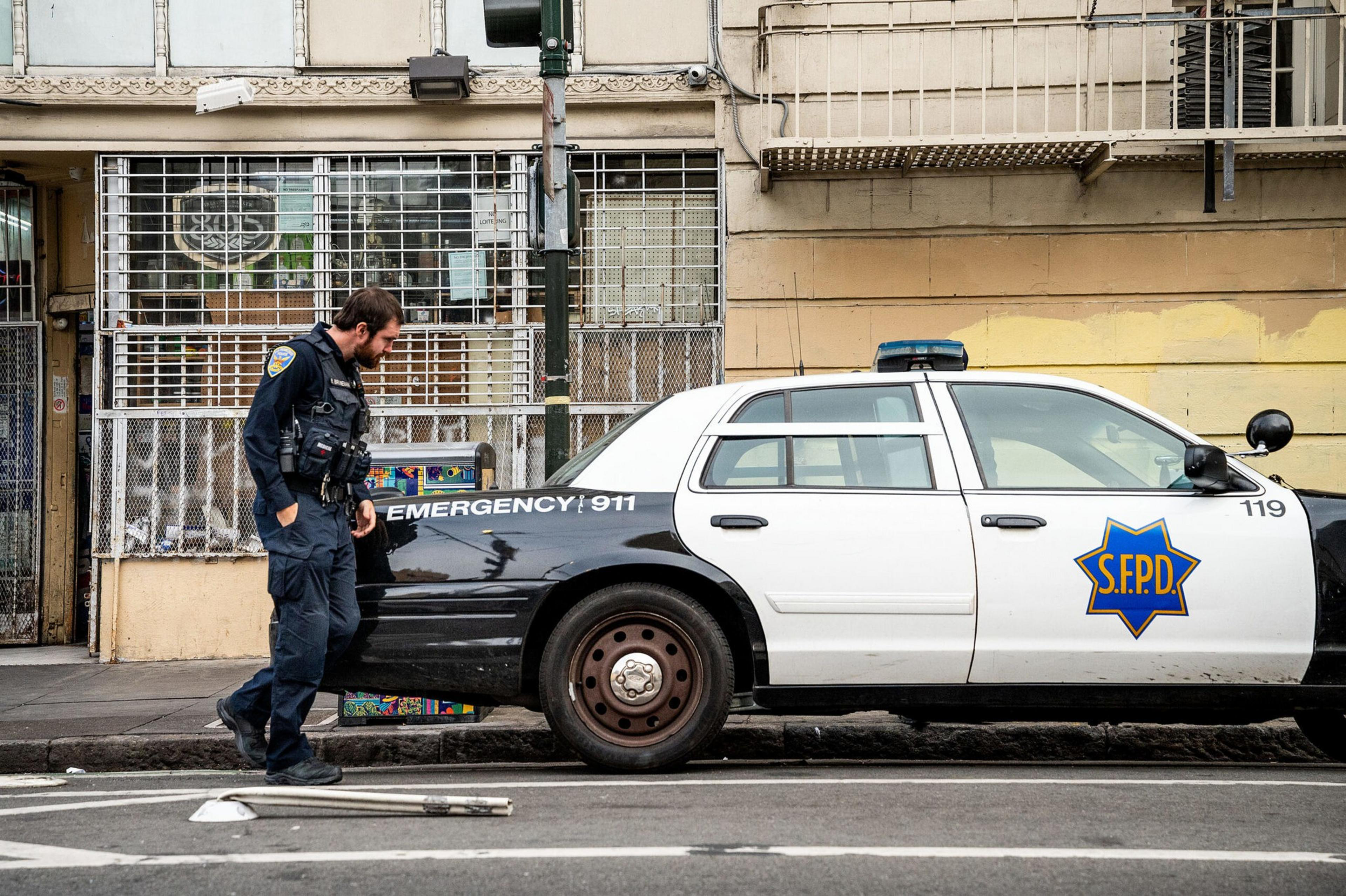 A police officer beside a squad