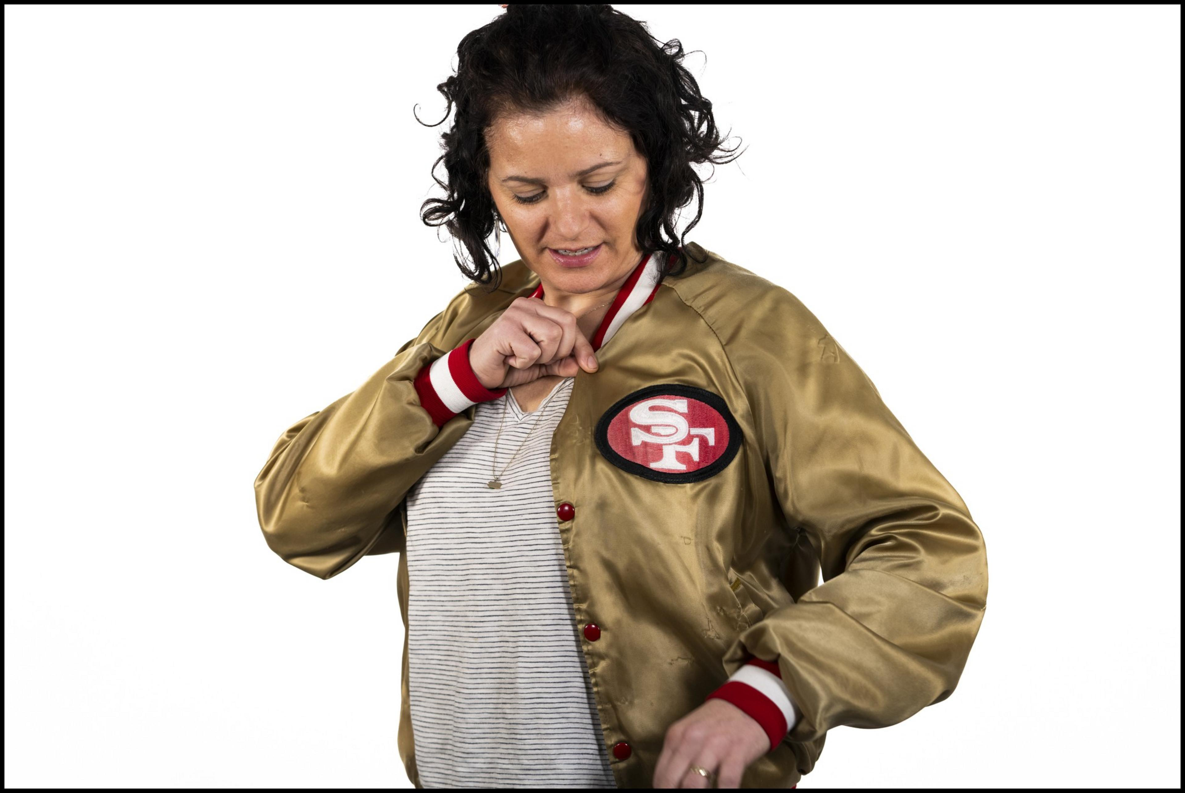 A person models a gold and red jacket. 