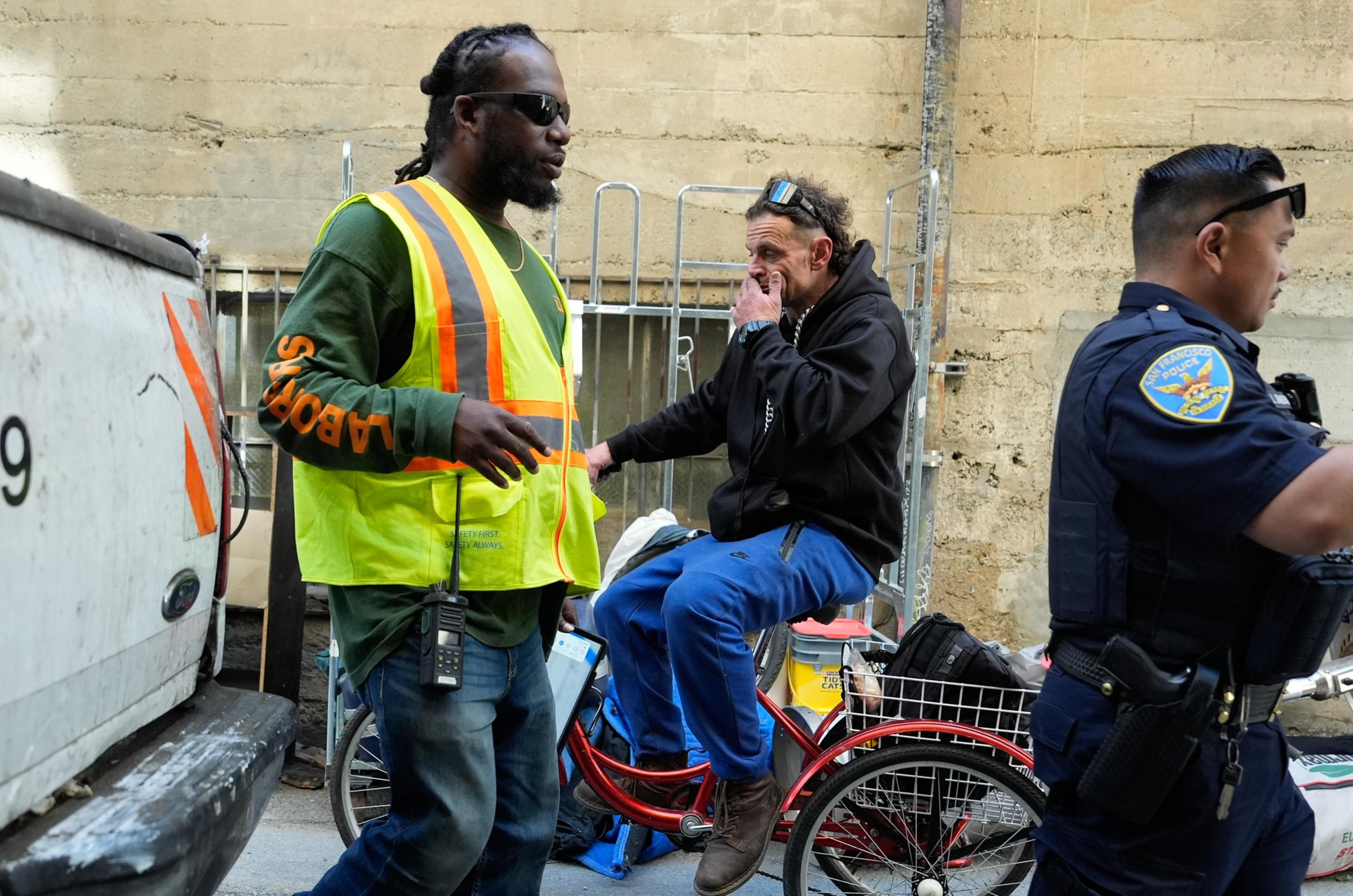 A homeless man is forced to leave an encampment.