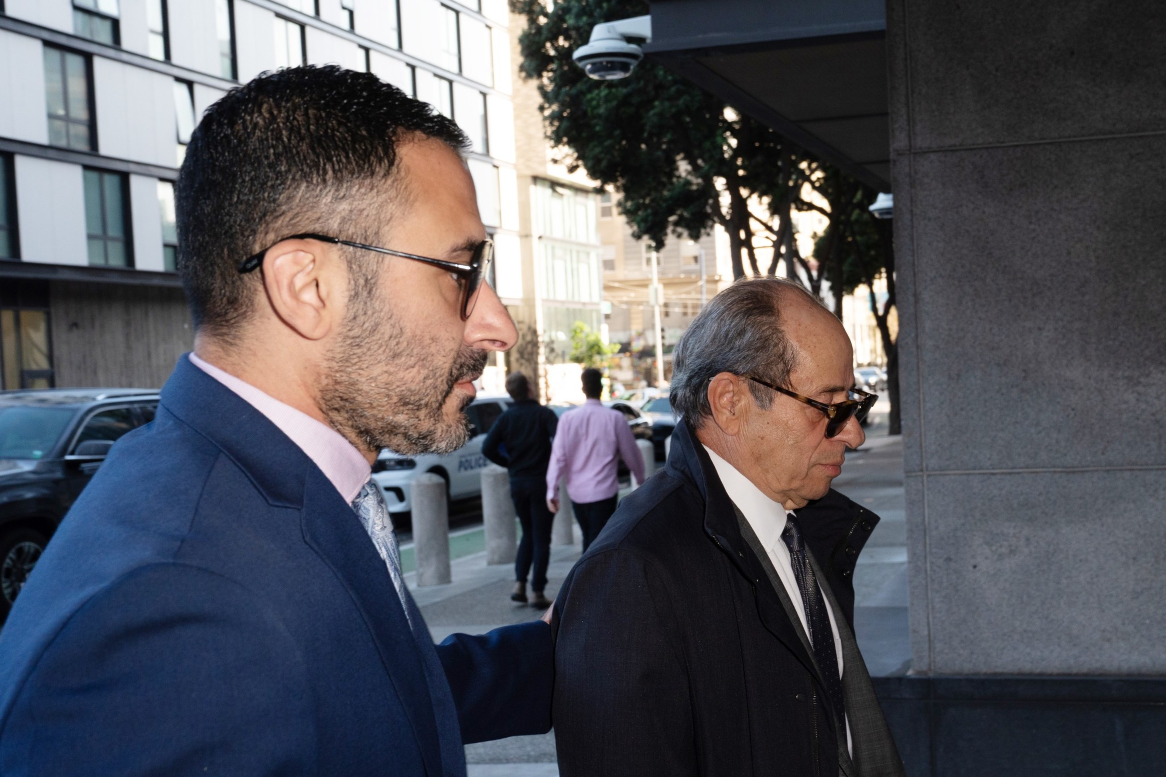 Two men walk into the federal building.