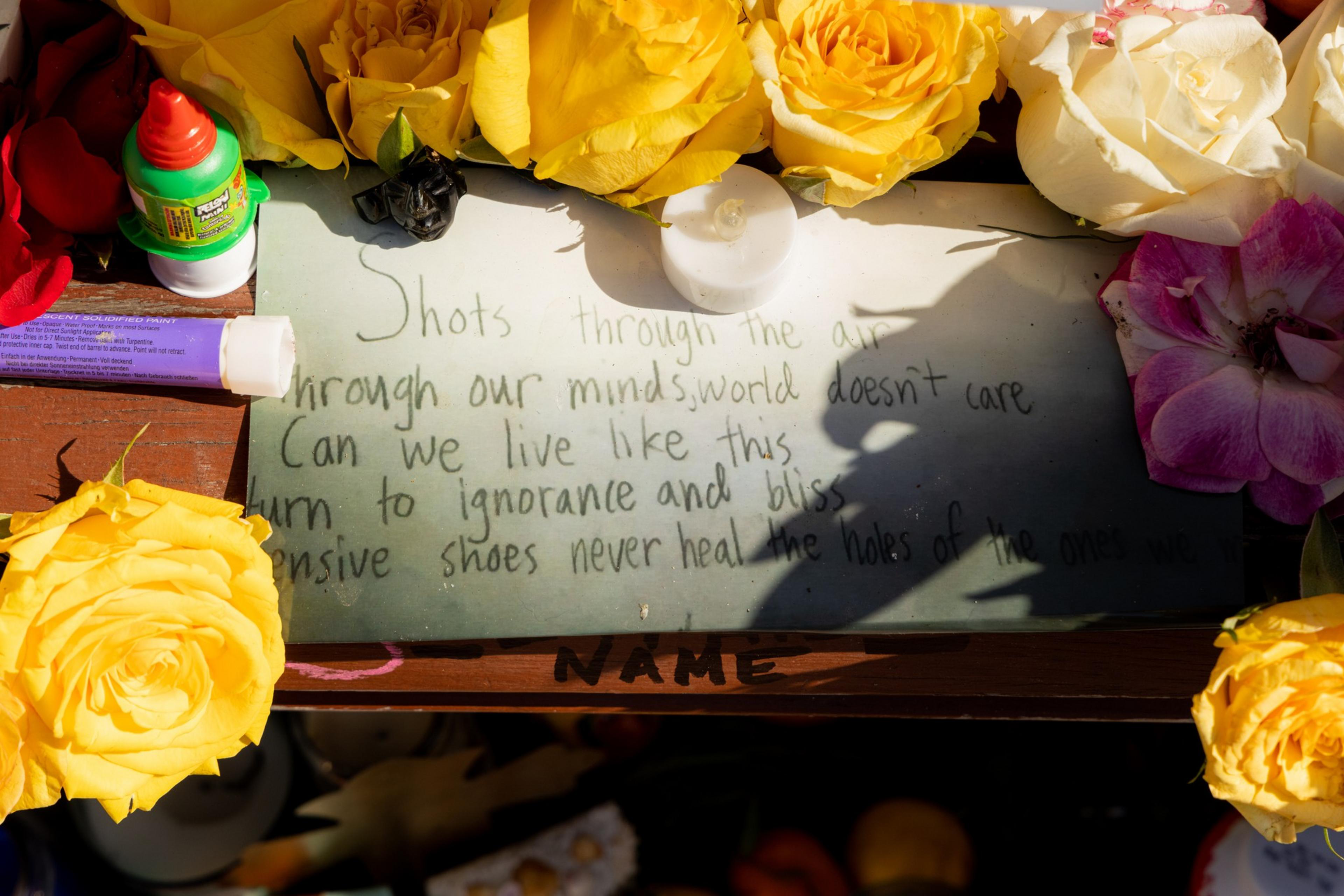 The image shows a chalkboard with a poetic message surrounded by flowers, a small container of Liqui-Mark poster paint, and a white tealight candle.