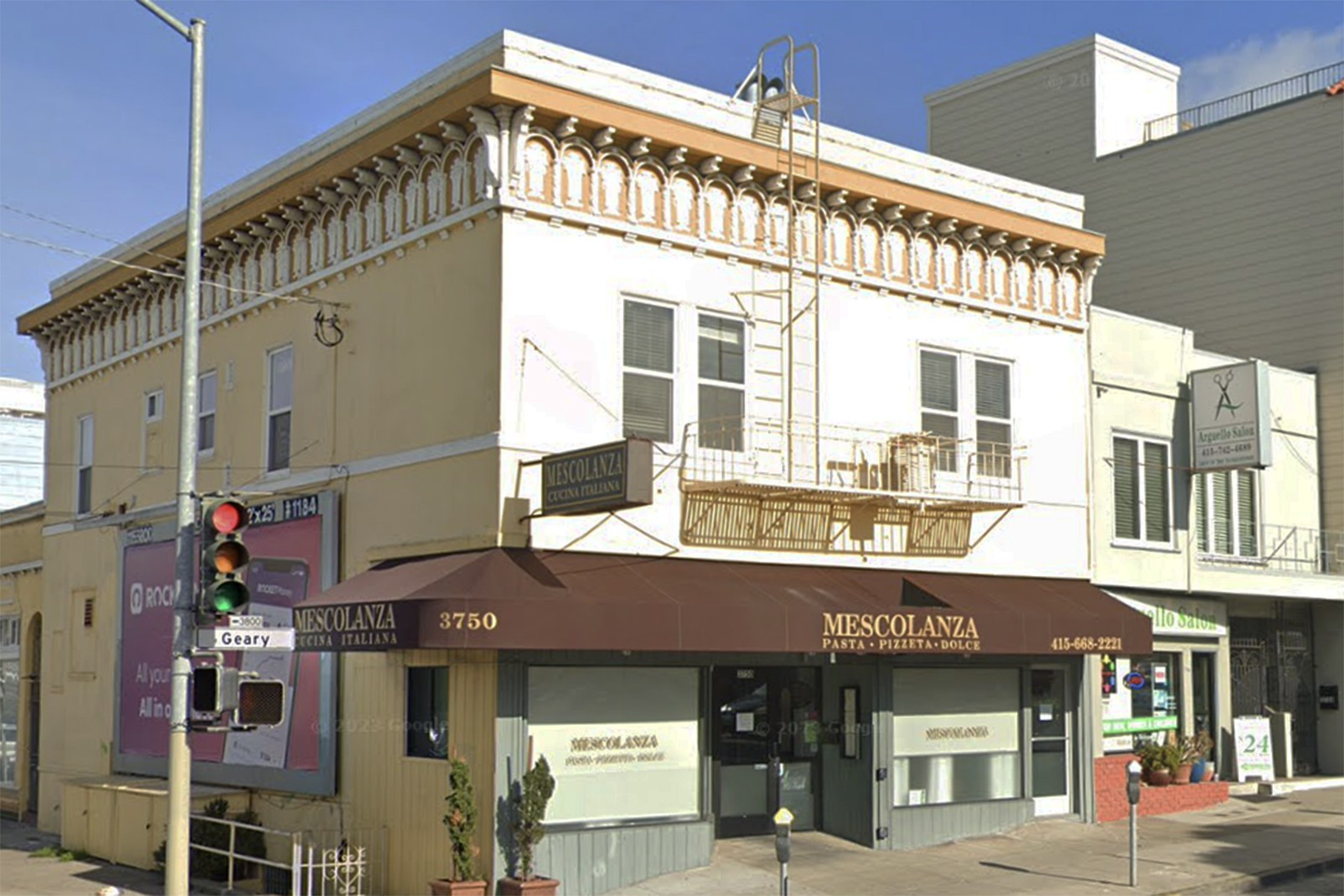 A two-story corner building houses Mescolanza, an Italian restaurant with a brown awning and a fire escape on the cream-colored upper floor.