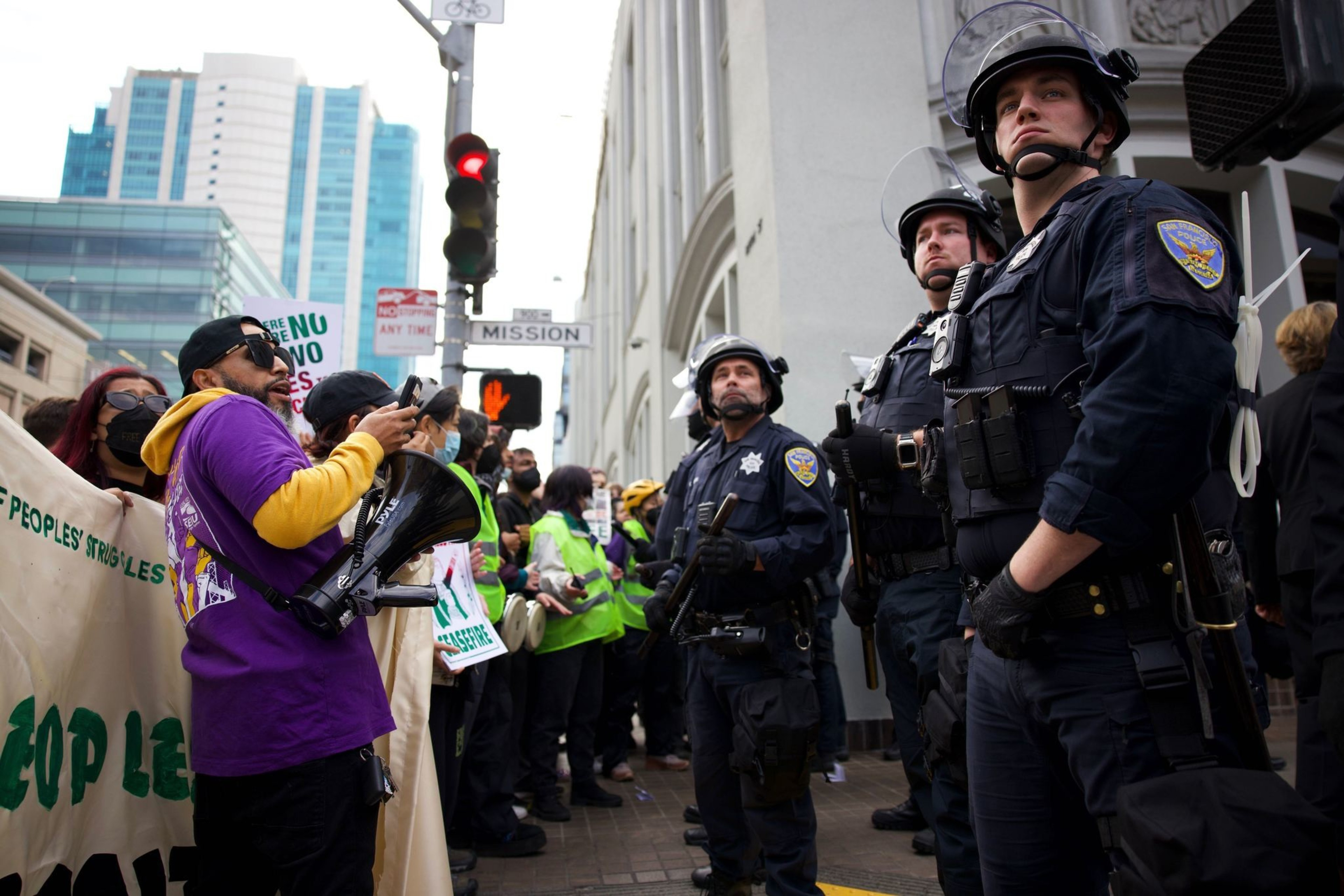 Police and activists stand face to face along at Mission Street.
