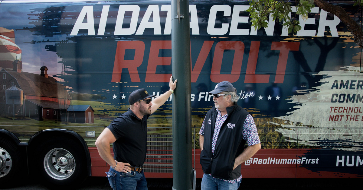 The AI Data Center Revolt bus parked near OpenAI's headquarters in San Francisco