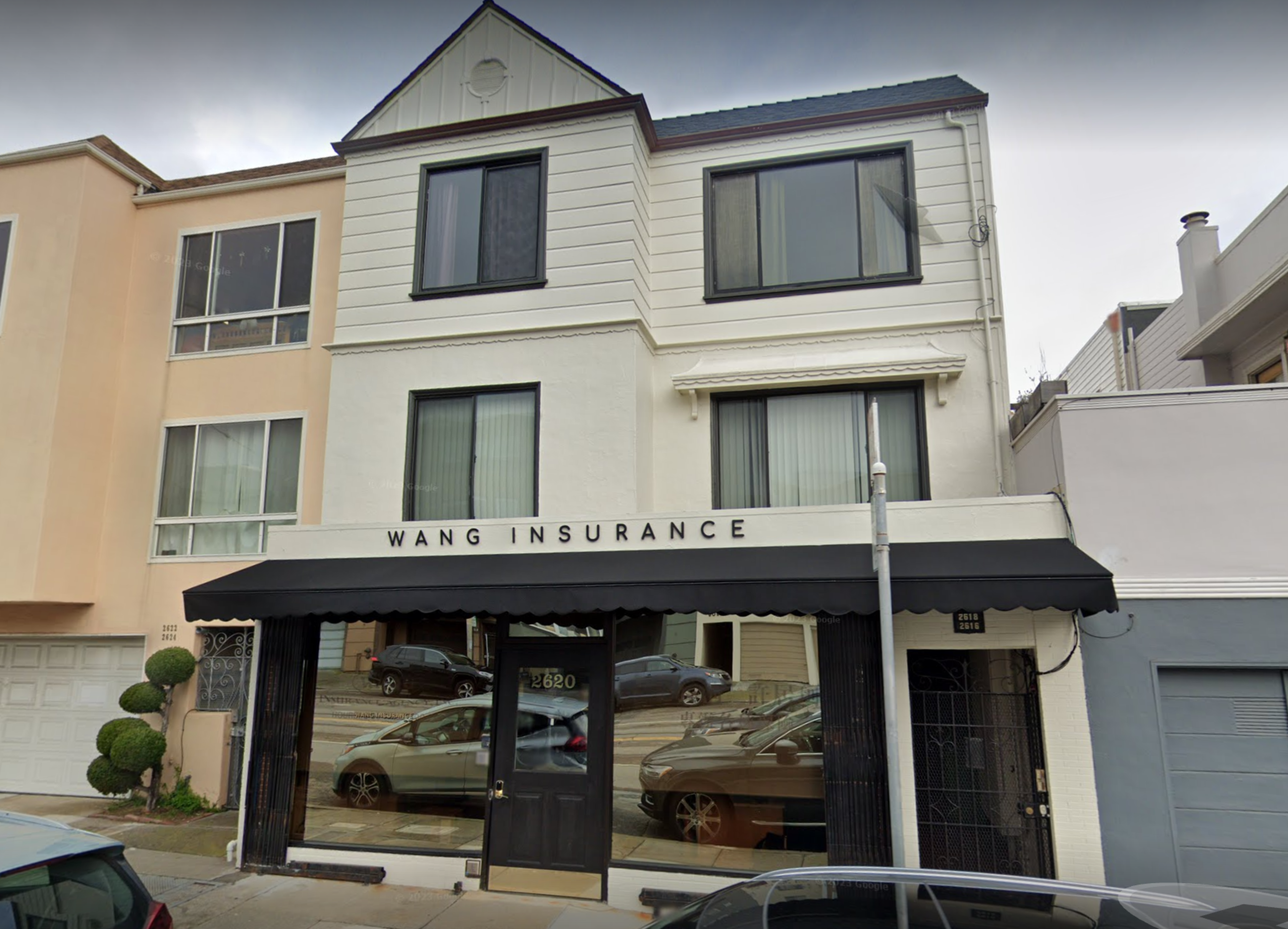 a building with a glass frontage and white painted walls