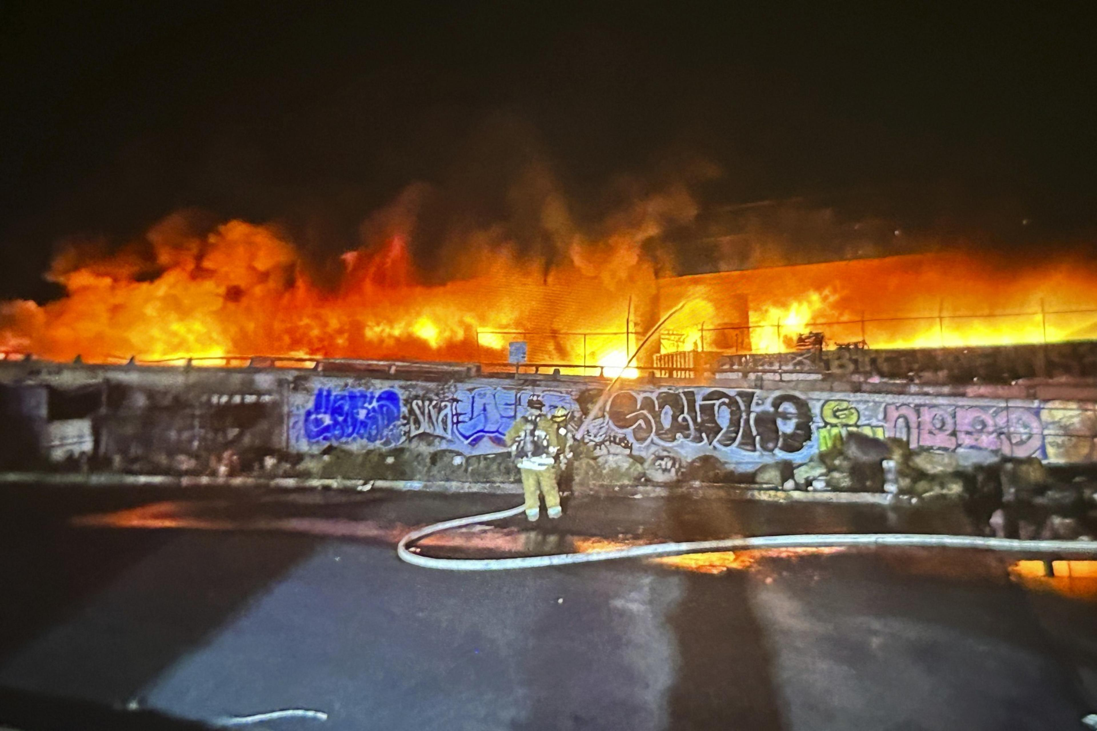 A firefighter sprays water.
