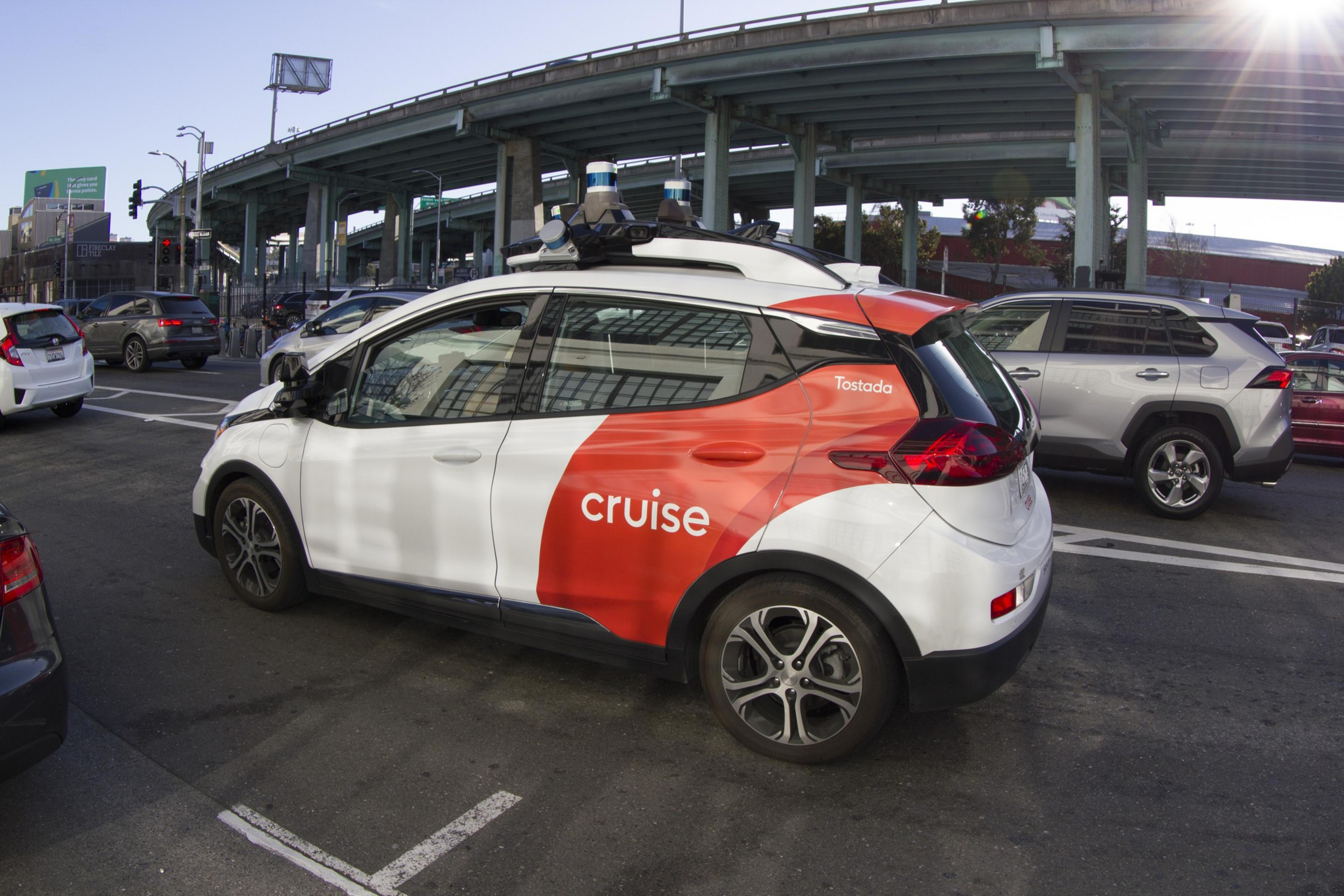 A Cruise vehicle, which is a driverless, autonomous robotaxi, at a stoplight during the day in San Francisco.