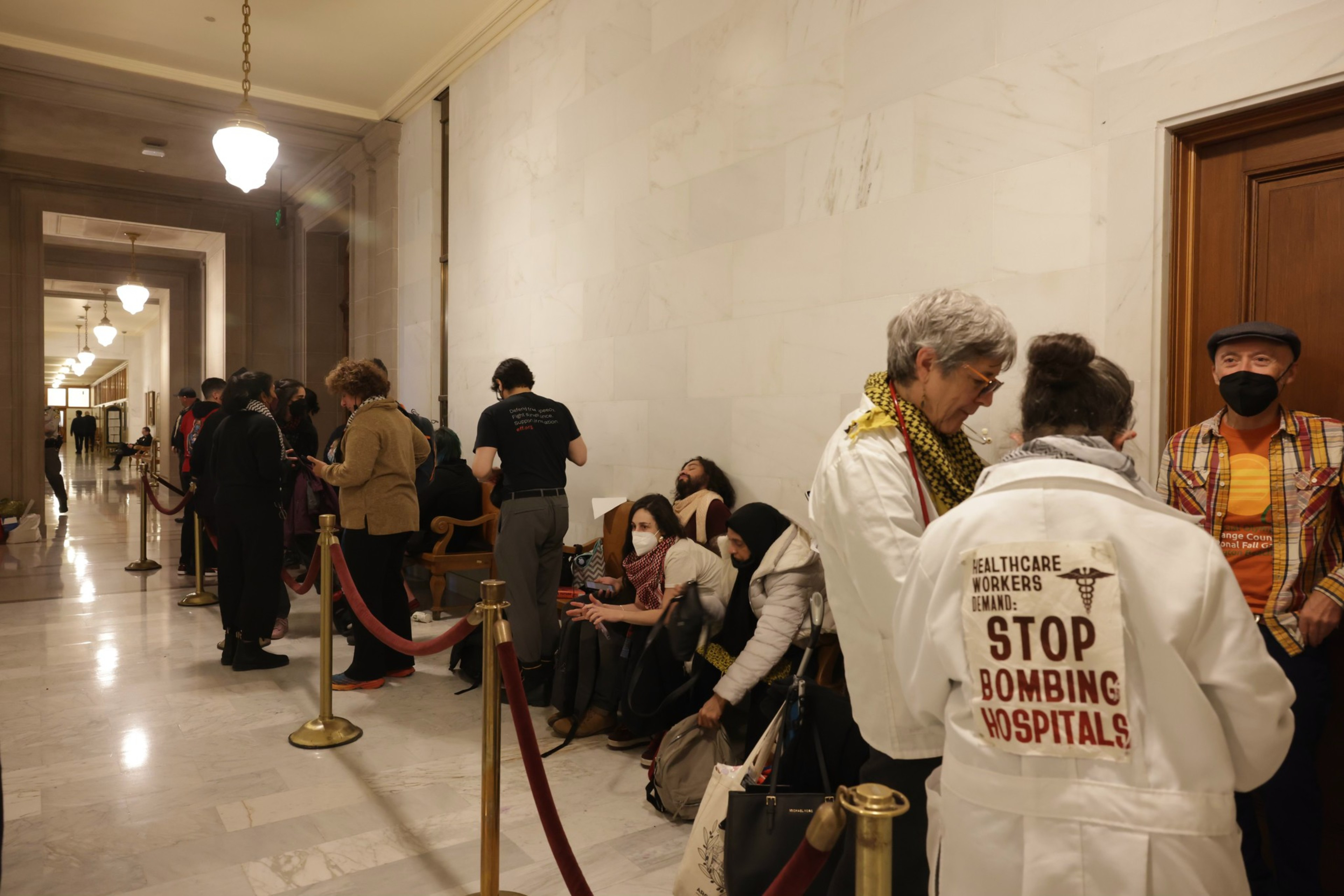 People wait in line to enter the Board of Supervisors meeting.