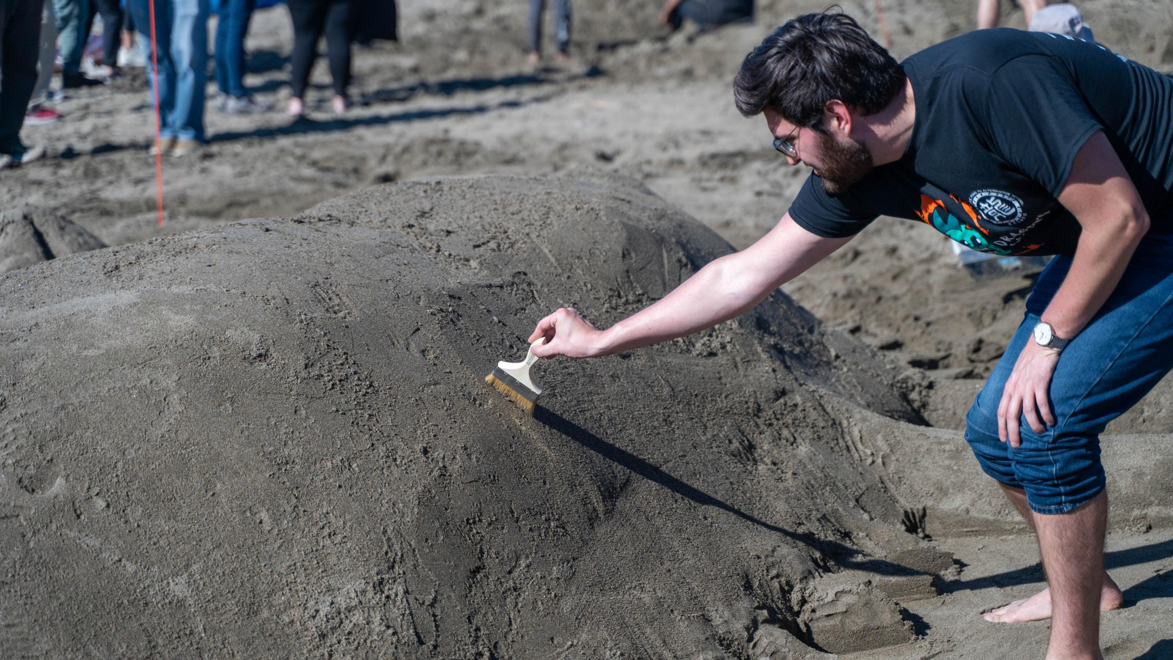 A giant sandcastle in the shape of a pumpkin sits on a San Francisco beach. 