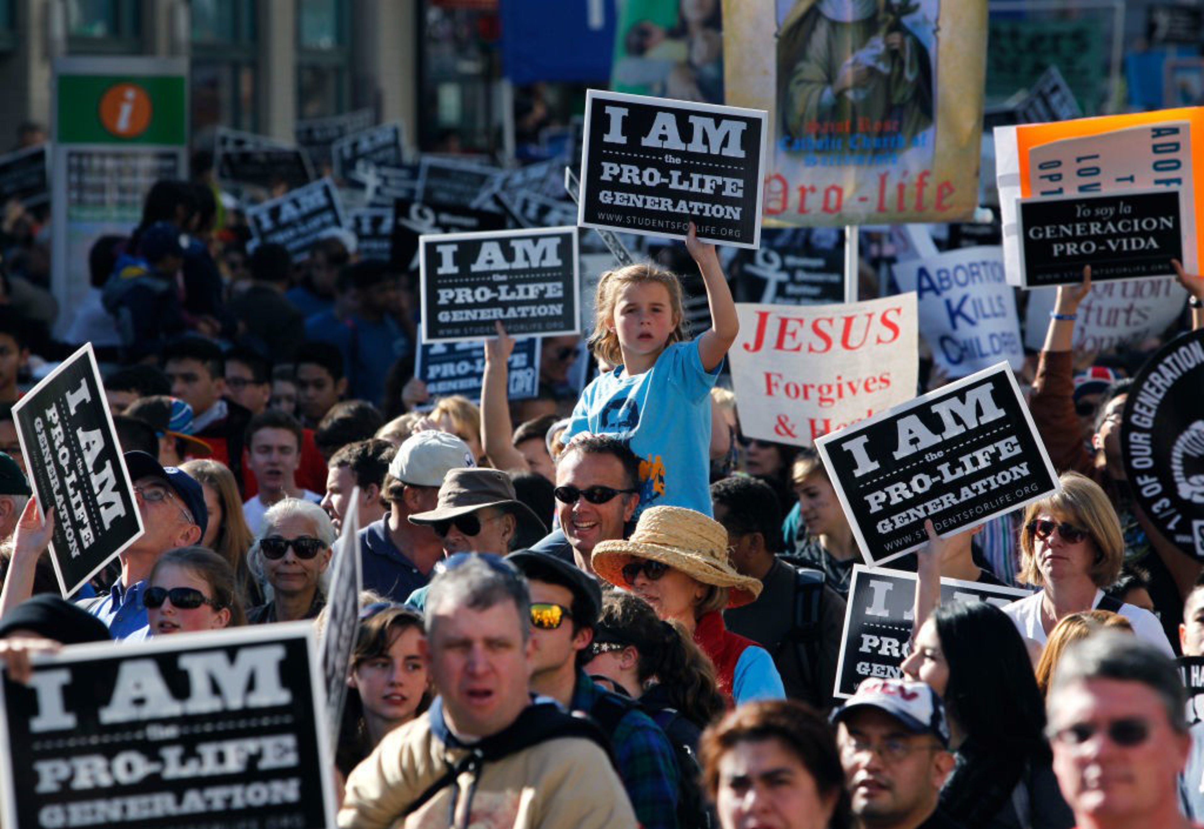 Protesters wave signs at an anti-abortion rally.