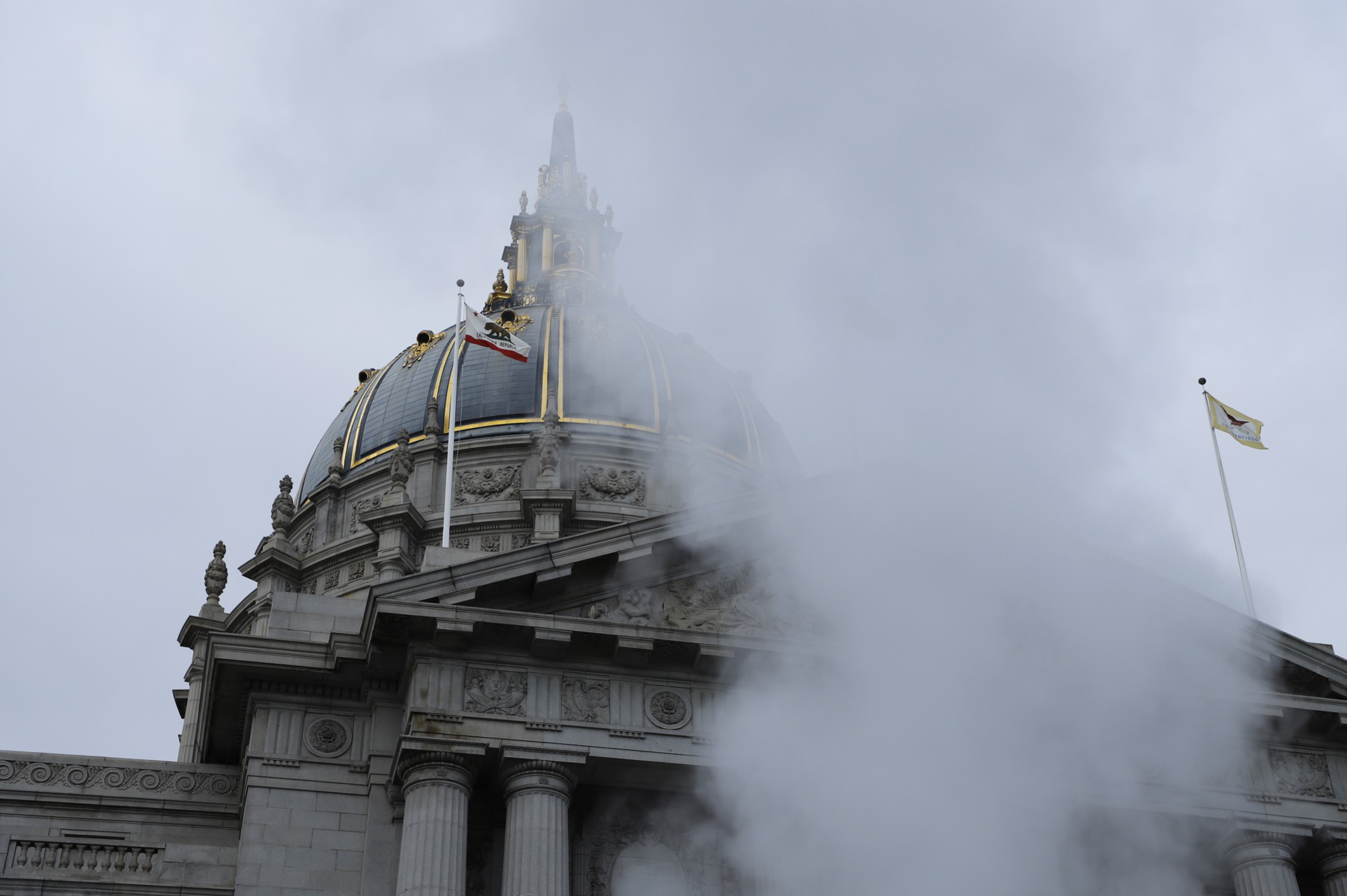 City Hall's dome on a cloudy day with steam rising in the foreground.