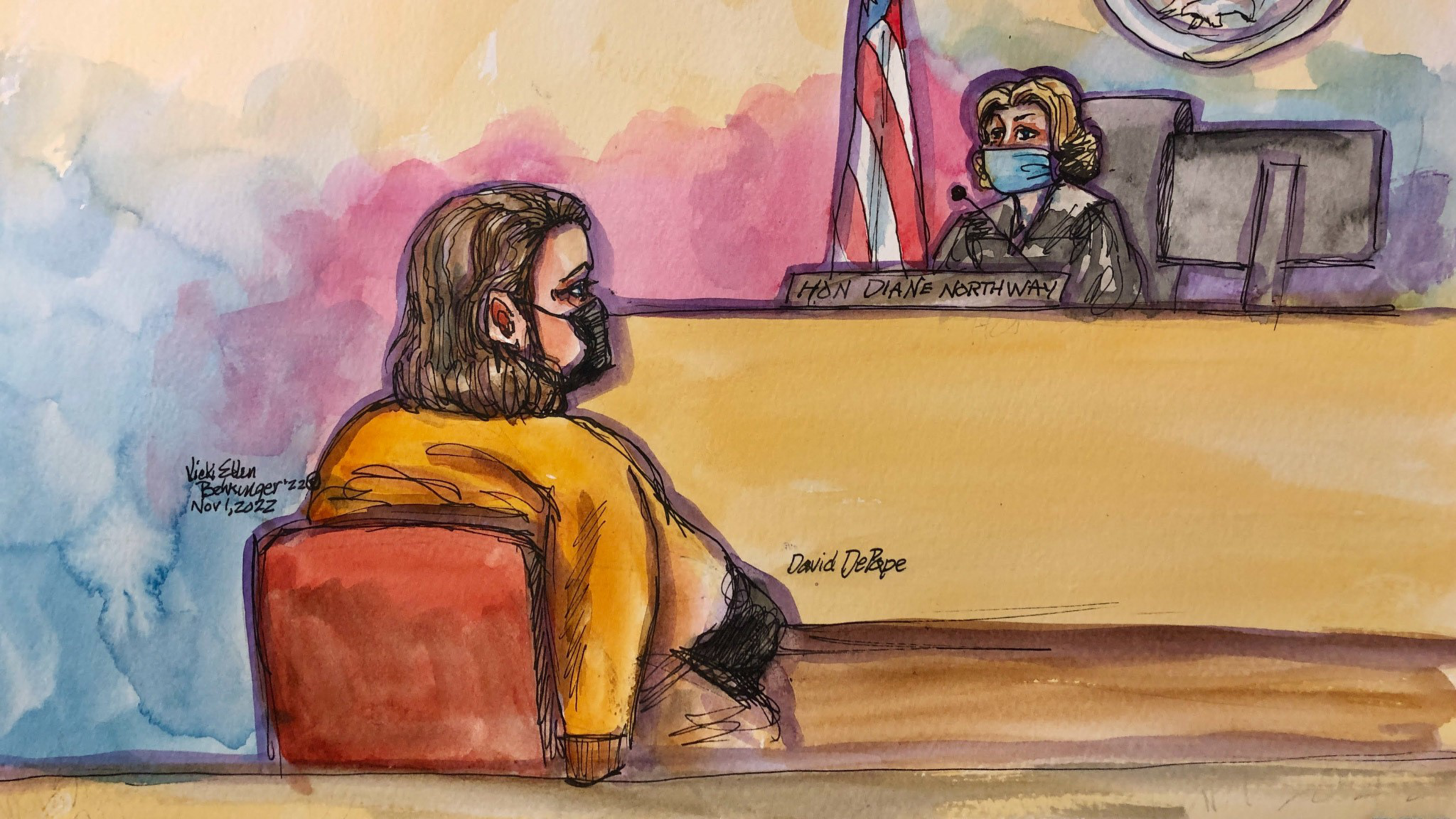 A courtroom scene with a person wearing an orange jumpsuit and black mask facing a judge in a mask, seated behind a bench with an American flag nearby.