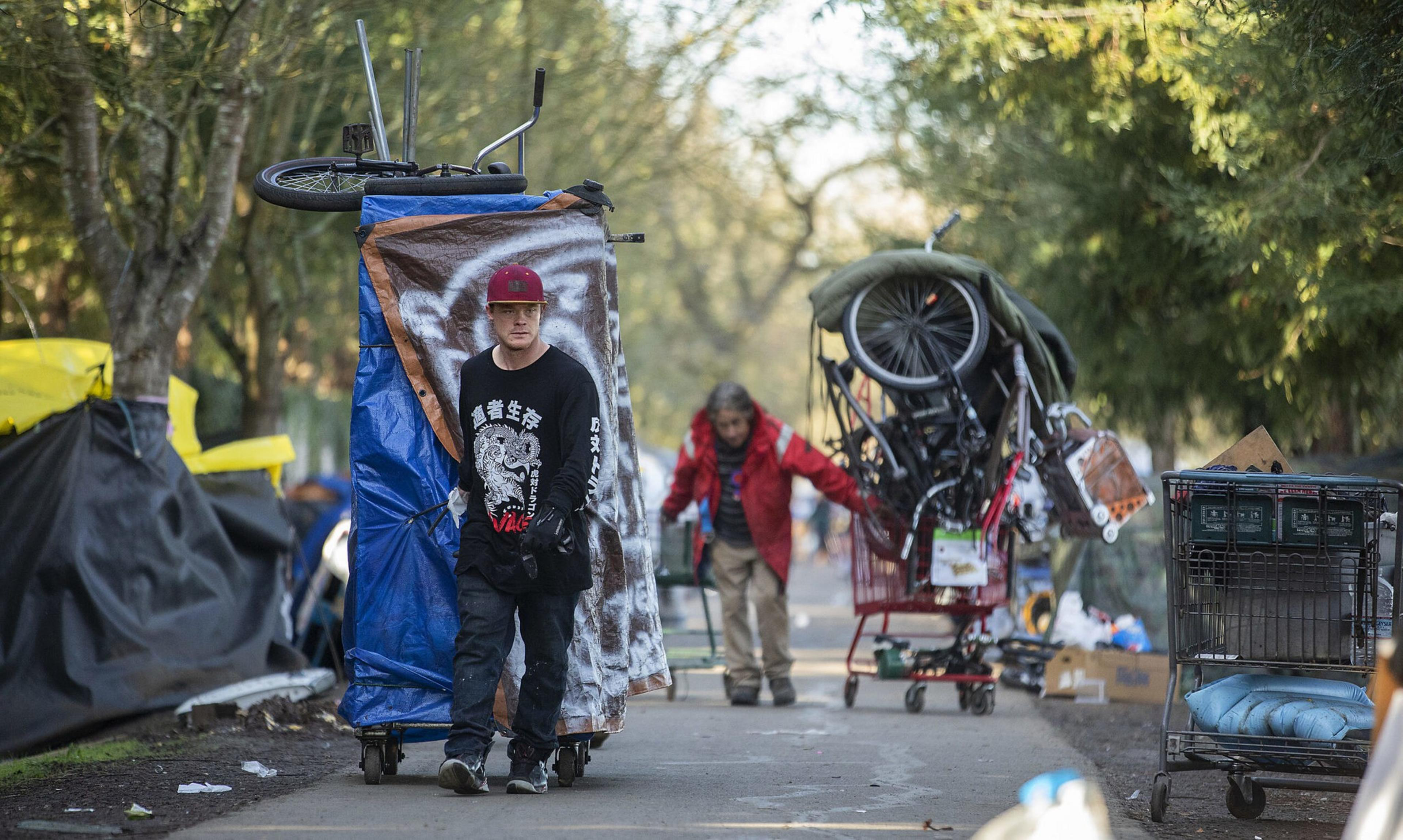 People experiencing homelessness move their belongings